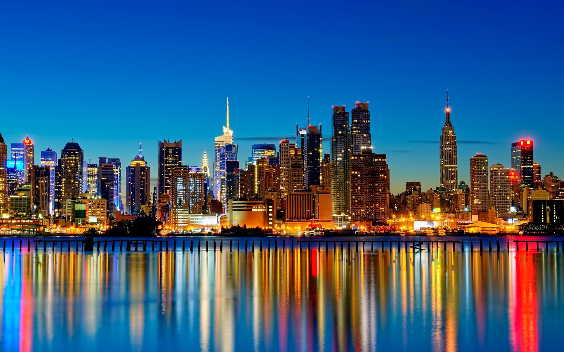 New York City skyline at dusk with water reflections HD Wallpaper