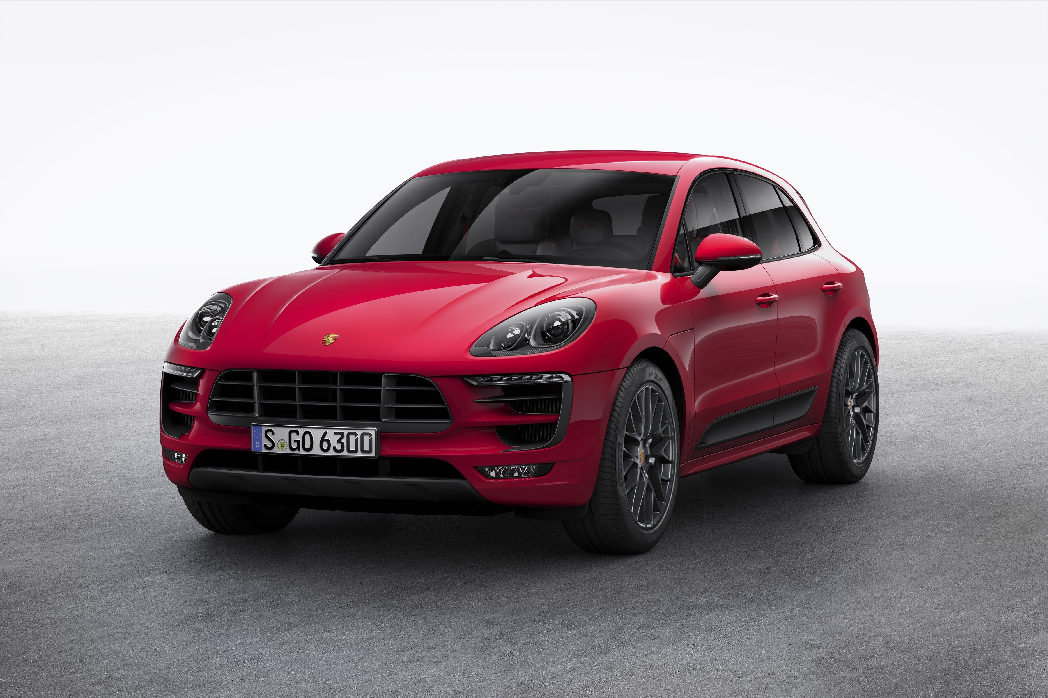 Red Porsche Macan GTS on a concrete surface HD Wallpaper