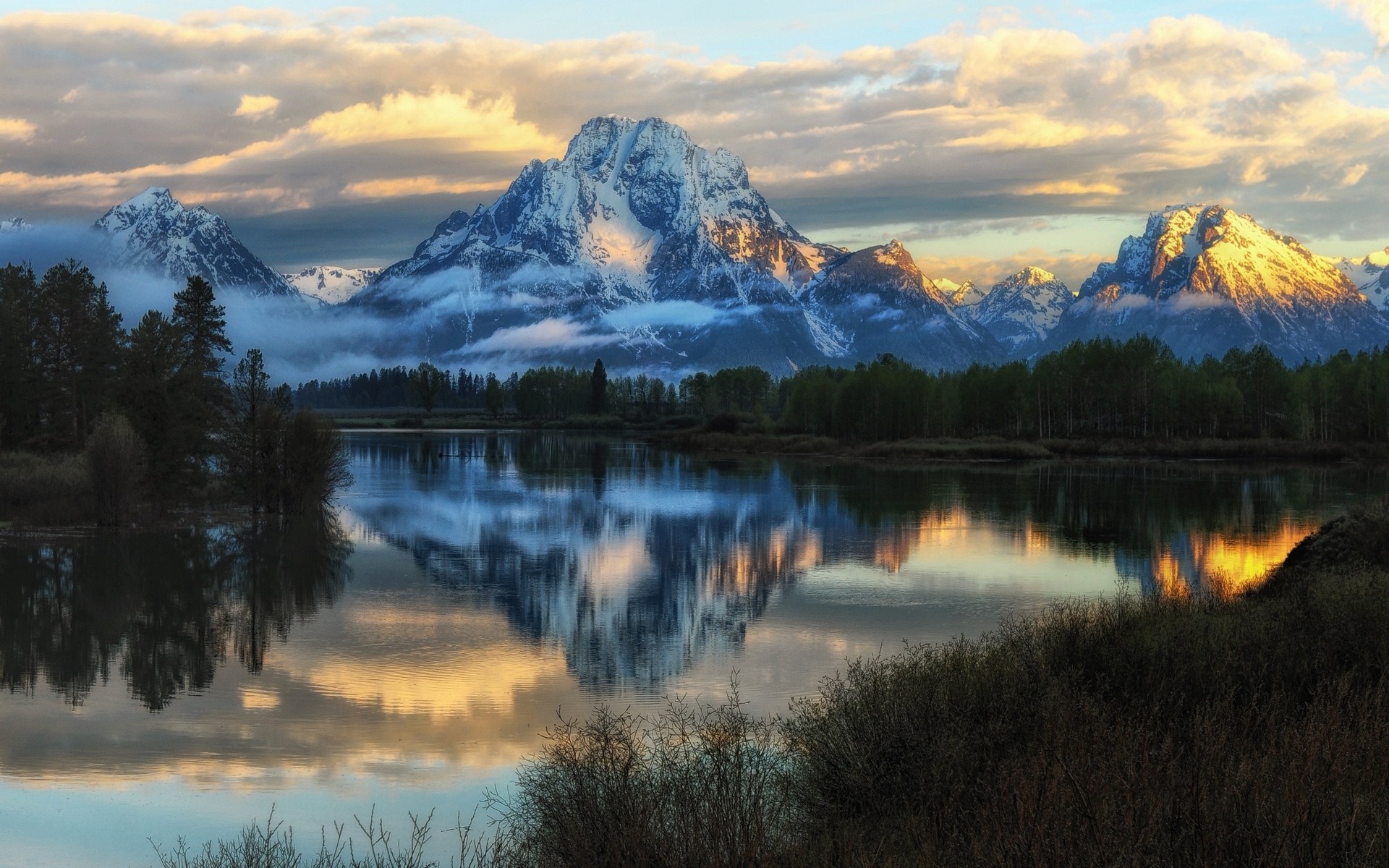 Sunlit Snowy Peaks and Reflective Lake at Dawn in Grand Teton National Park HD Wallpaper
