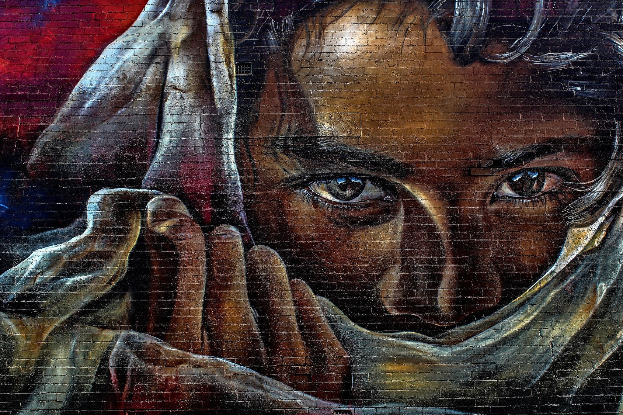 Graffiti mural of a person's face covered by cloth HD Wallpaper
