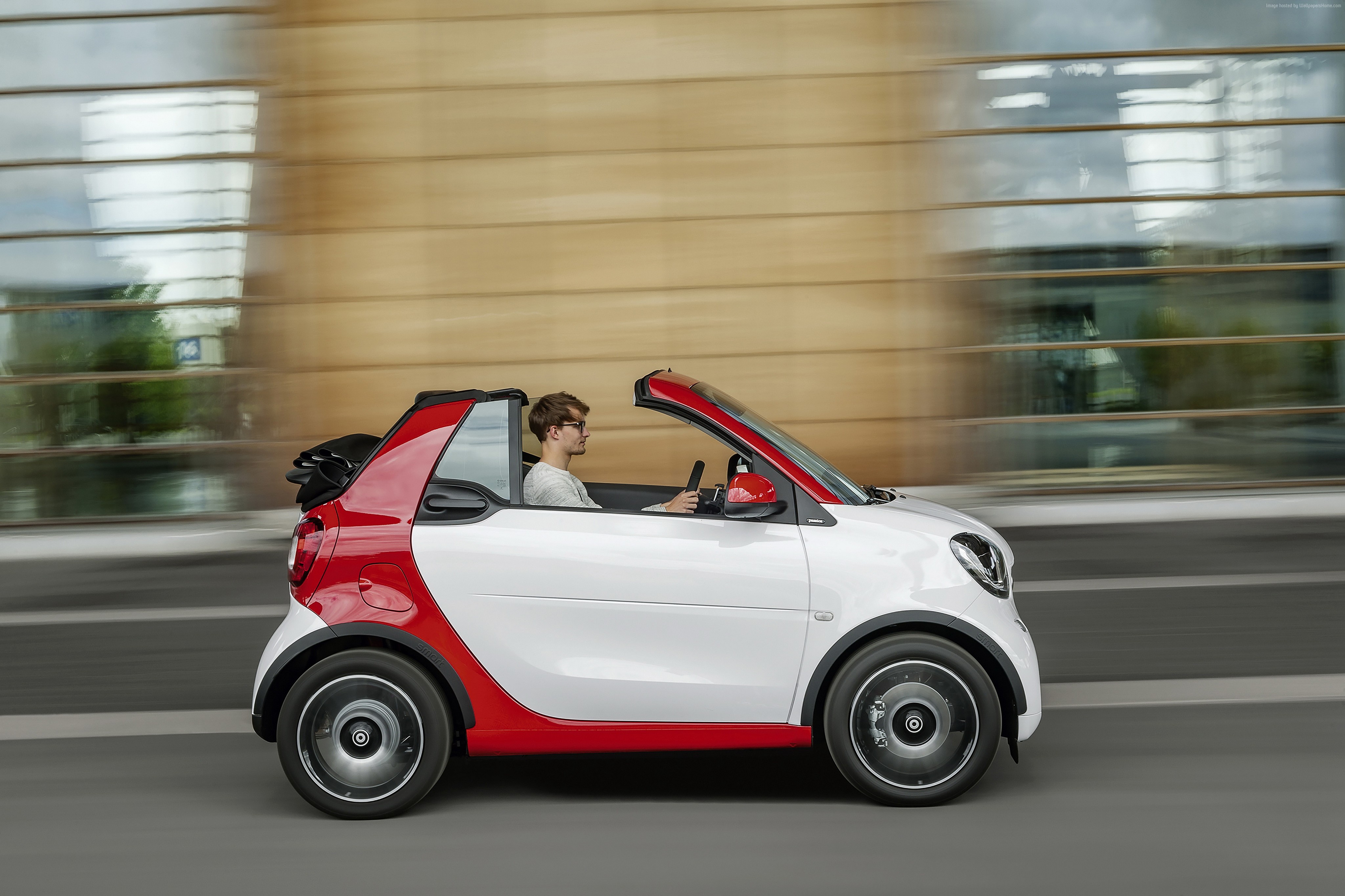 Smart Fortwo Passion Cabrio driving on a street HD Wallpaper