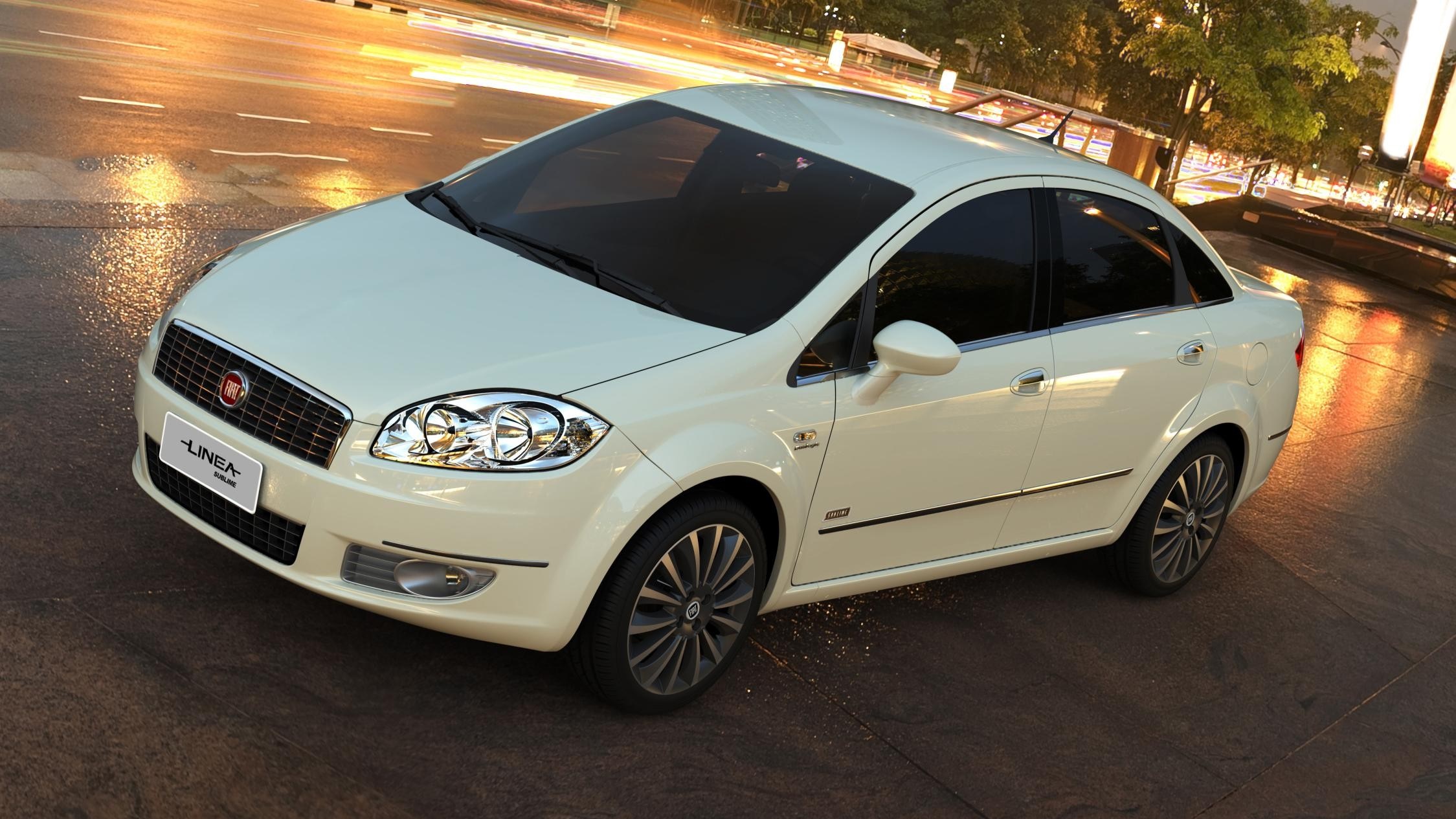 White Fiat Linea sedan parked on a wet street at night HD Wallpaper
