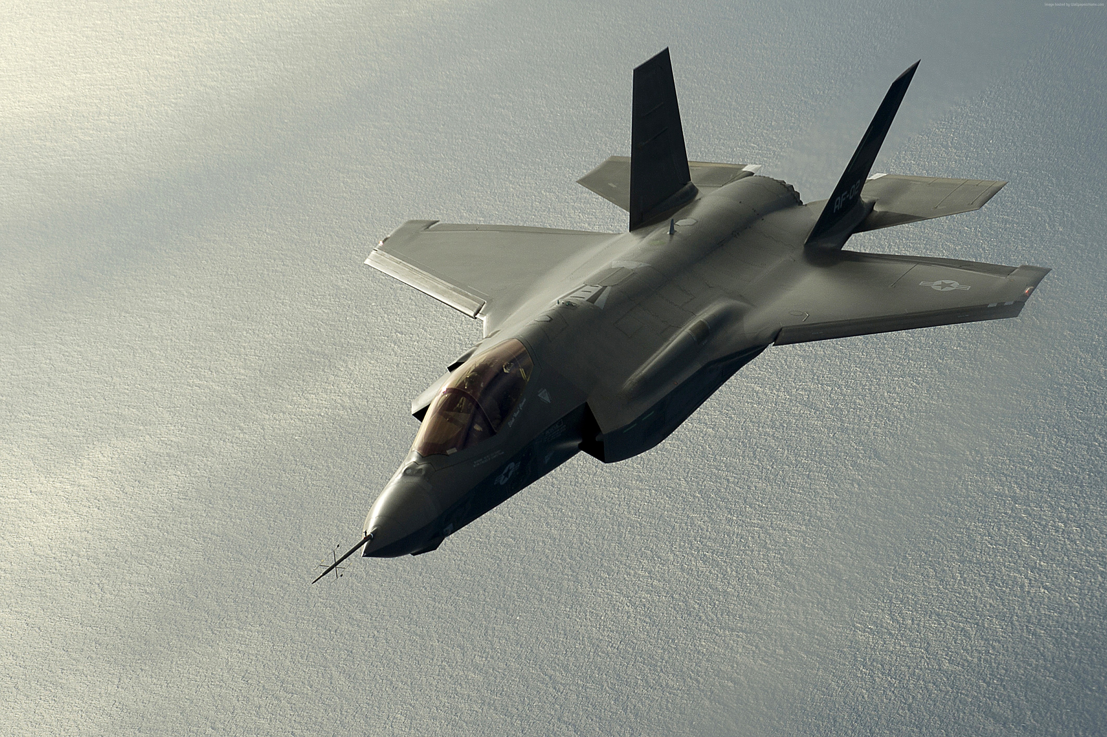Lockheed F-35 Lightning II fighter jet flying over water HD Wallpaper