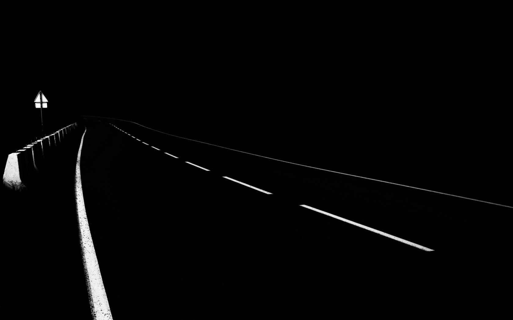 Monochrome highway at night with traffic sign HD Wallpaper