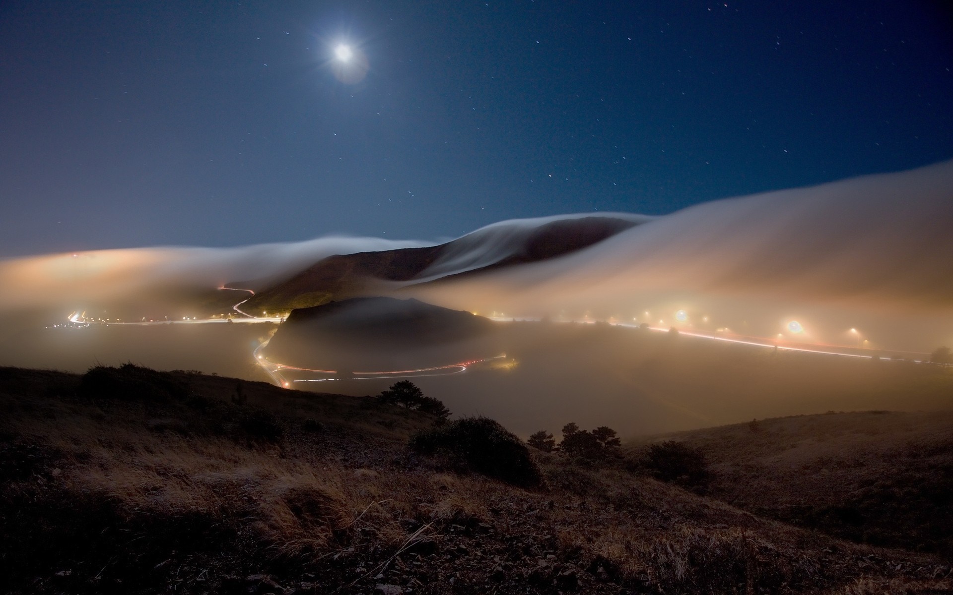 Foggy night landscape with moonlight and city lights HD Wallpaper