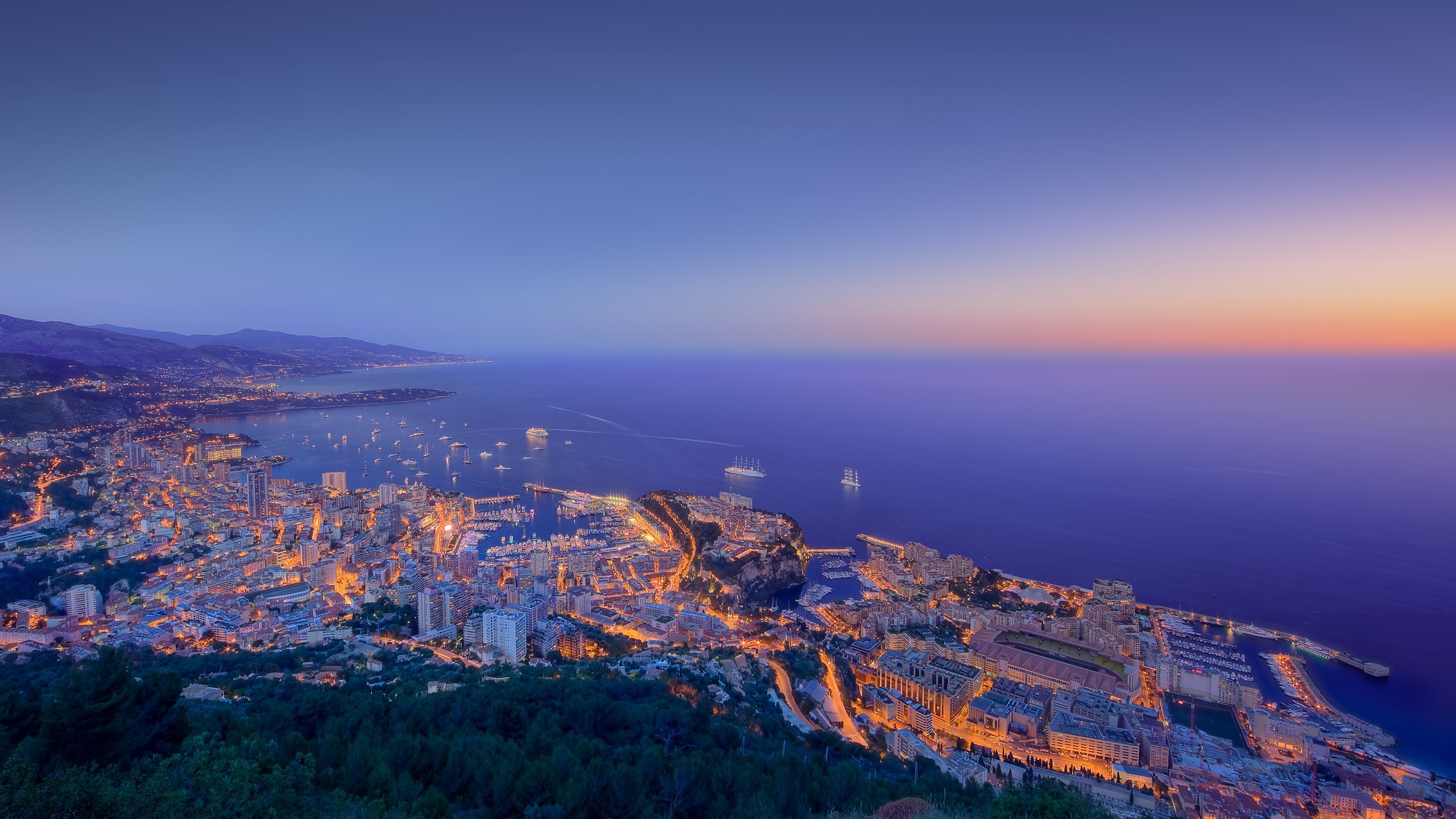 Cityscape of Monaco at dusk with boats in the harbor HD Wallpaper