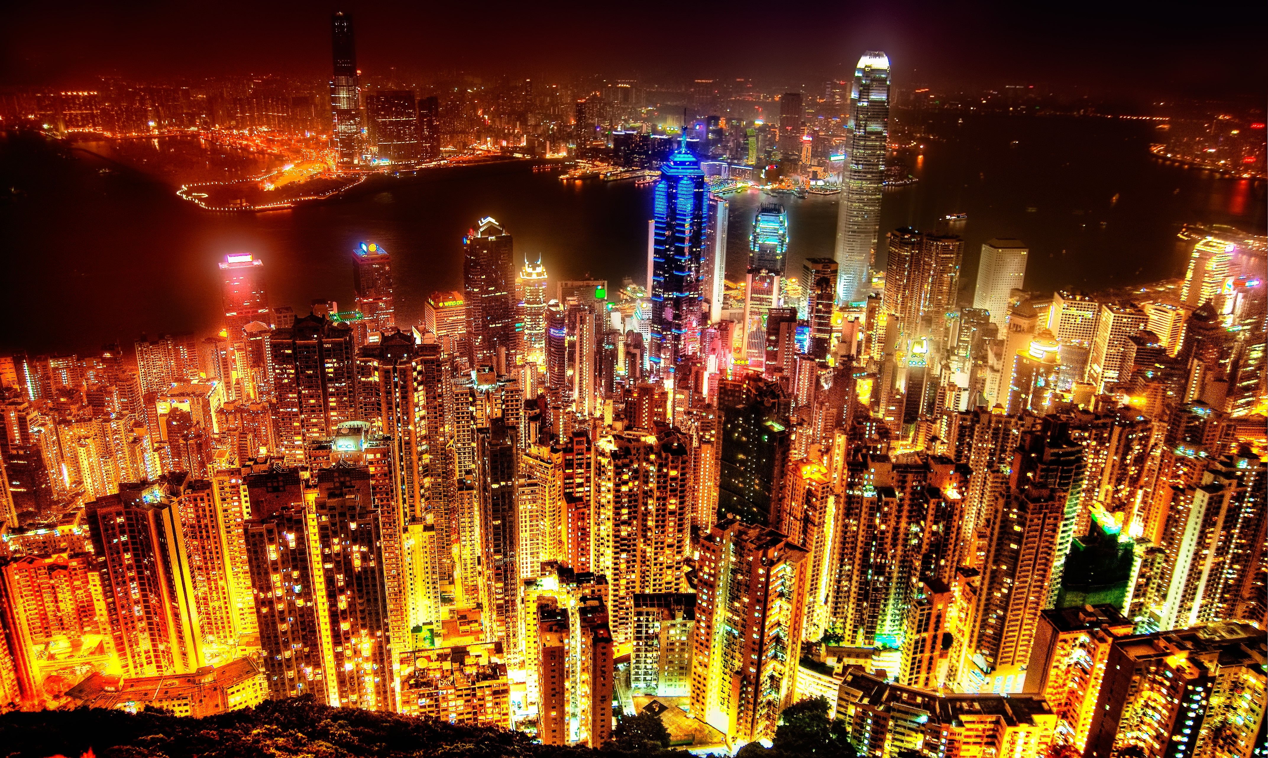 Hong Kong cityscape at night with illuminated skyscrapers HD Wallpaper