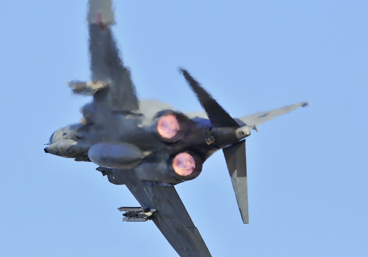 Rear view of a fighter jet with afterburners on HD Wallpaper