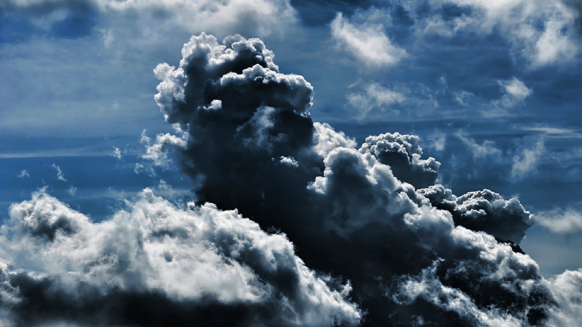 Dark storm clouds in a blue sky HD Wallpaper