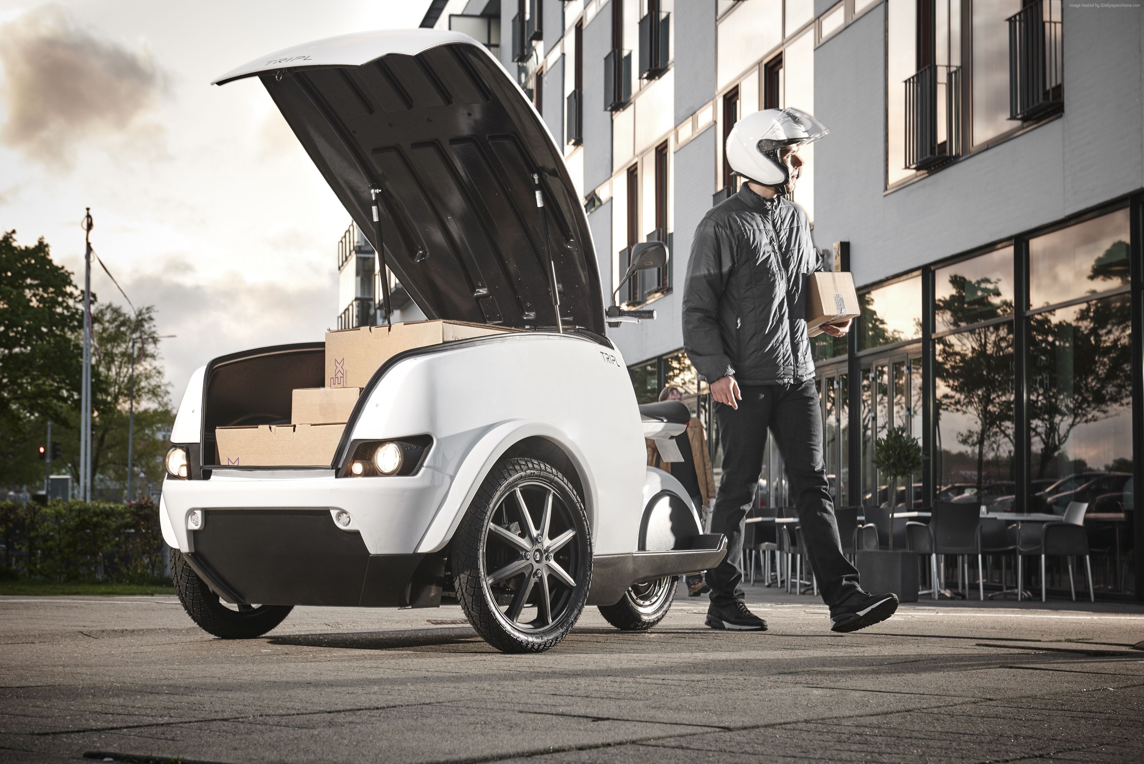 White Tripl electrocycle with open trunk and delivery person HD Wallpaper