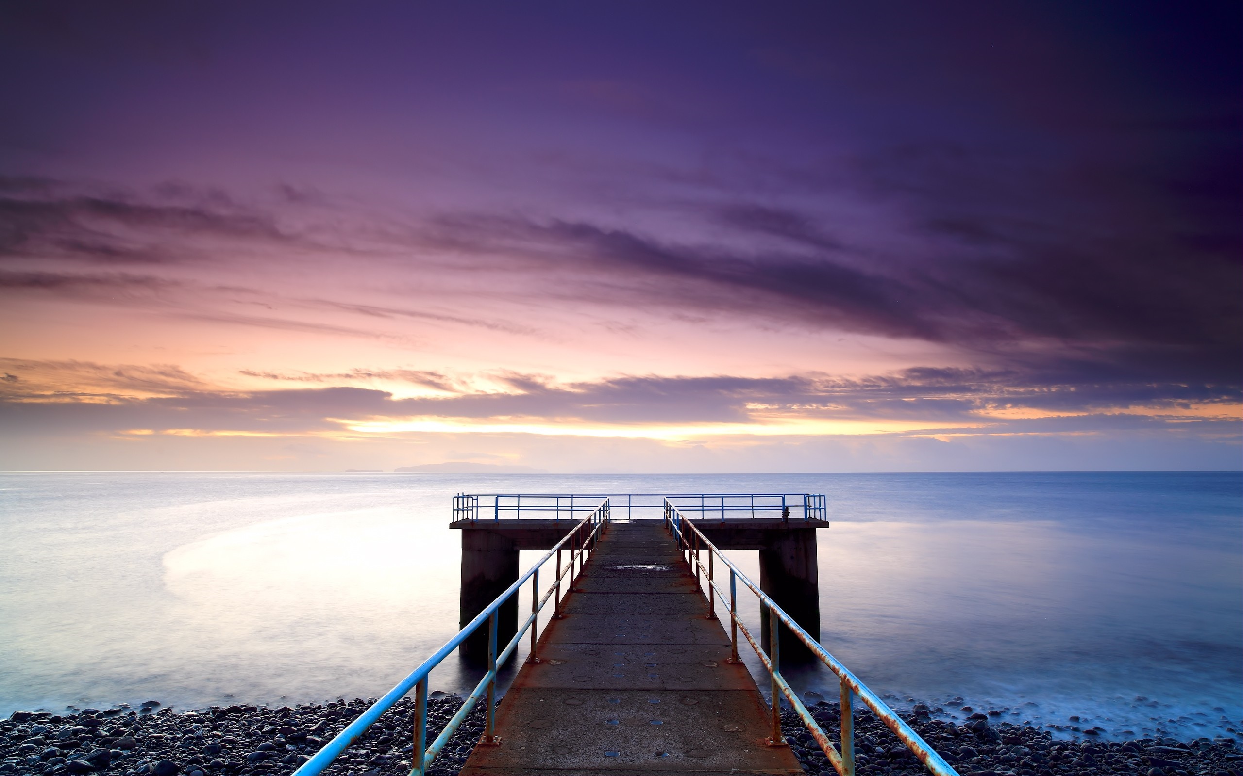 Pier over the sea at sunset with purple clouds HD Wallpaper