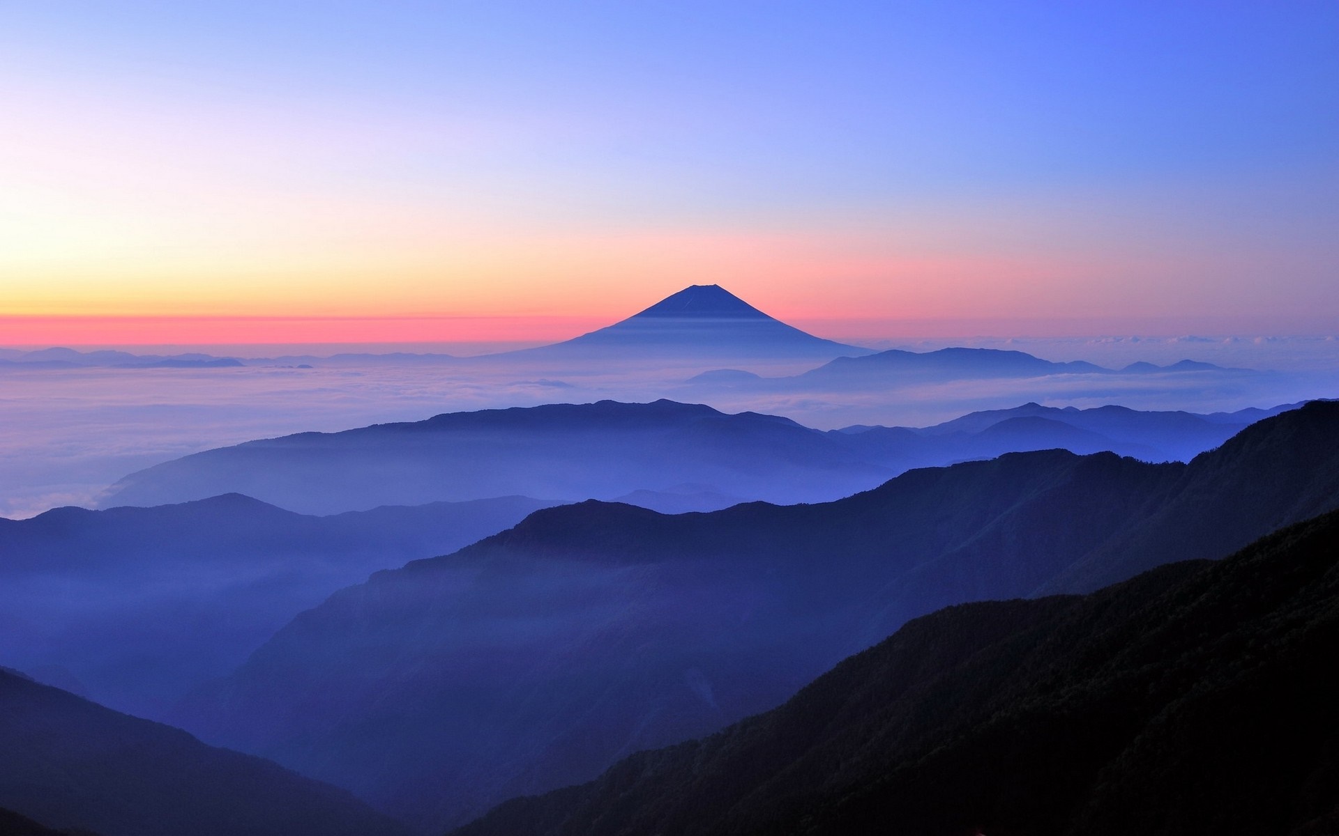 Mount Fuji at sunrise over a sea of clouds HD Wallpaper