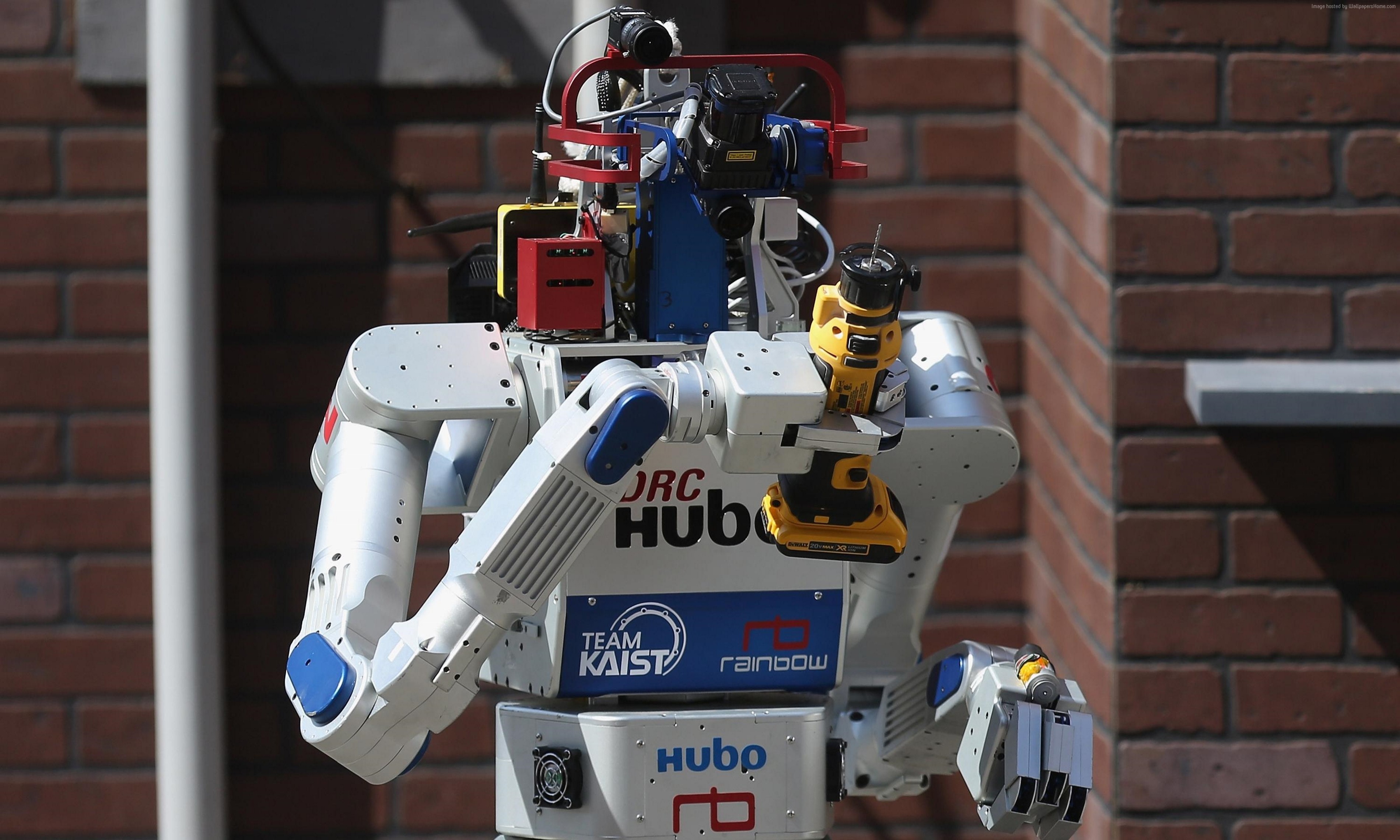 DRC-HUBO robot holding a yellow power drill HD Wallpaper
