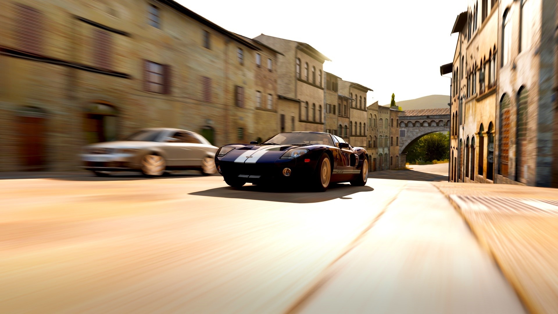 Ford GT driving through a European town HD Wallpaper