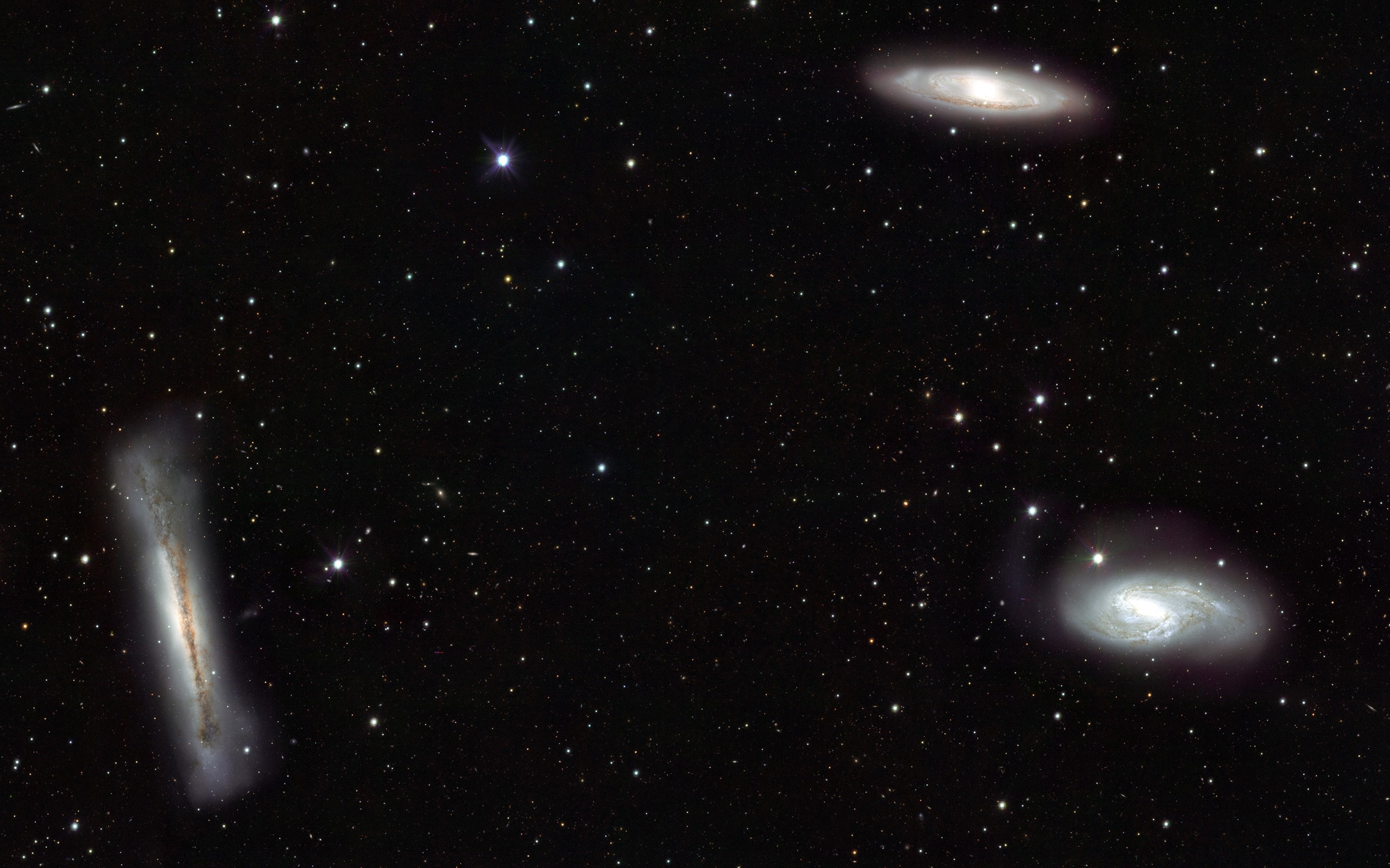 Three galaxies and stars in deep space HD Wallpaper