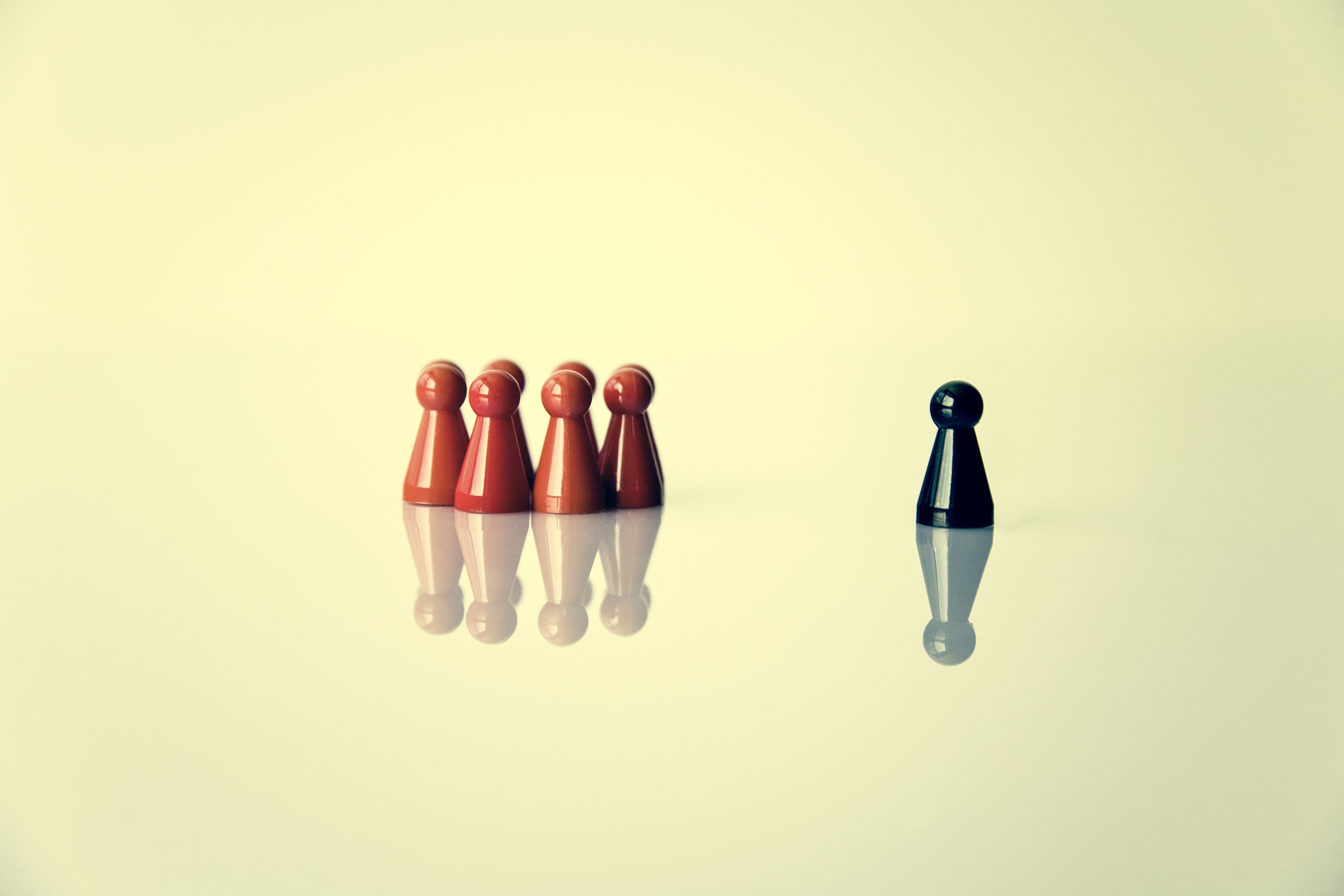 Red and black game pawns on reflective surface HD Wallpaper
