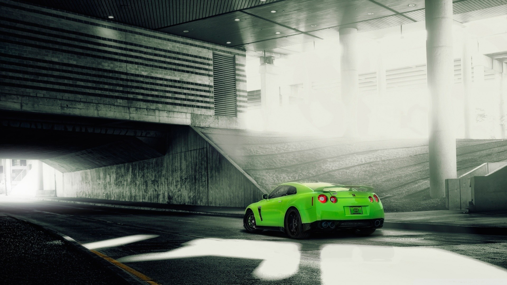 Green Nissan GT-R parked under a concrete overpass HD Wallpaper