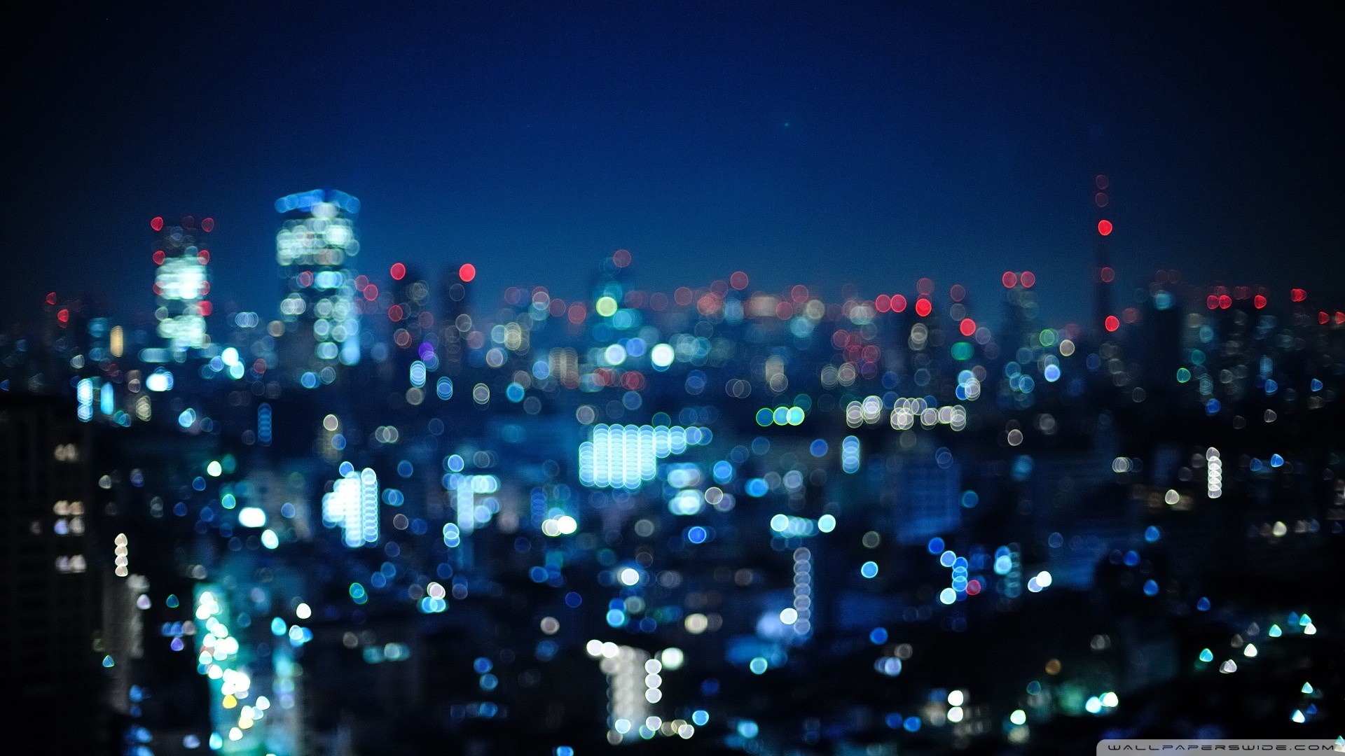 Blurred Cityscape at Night with Bokeh Lights HD Wallpaper