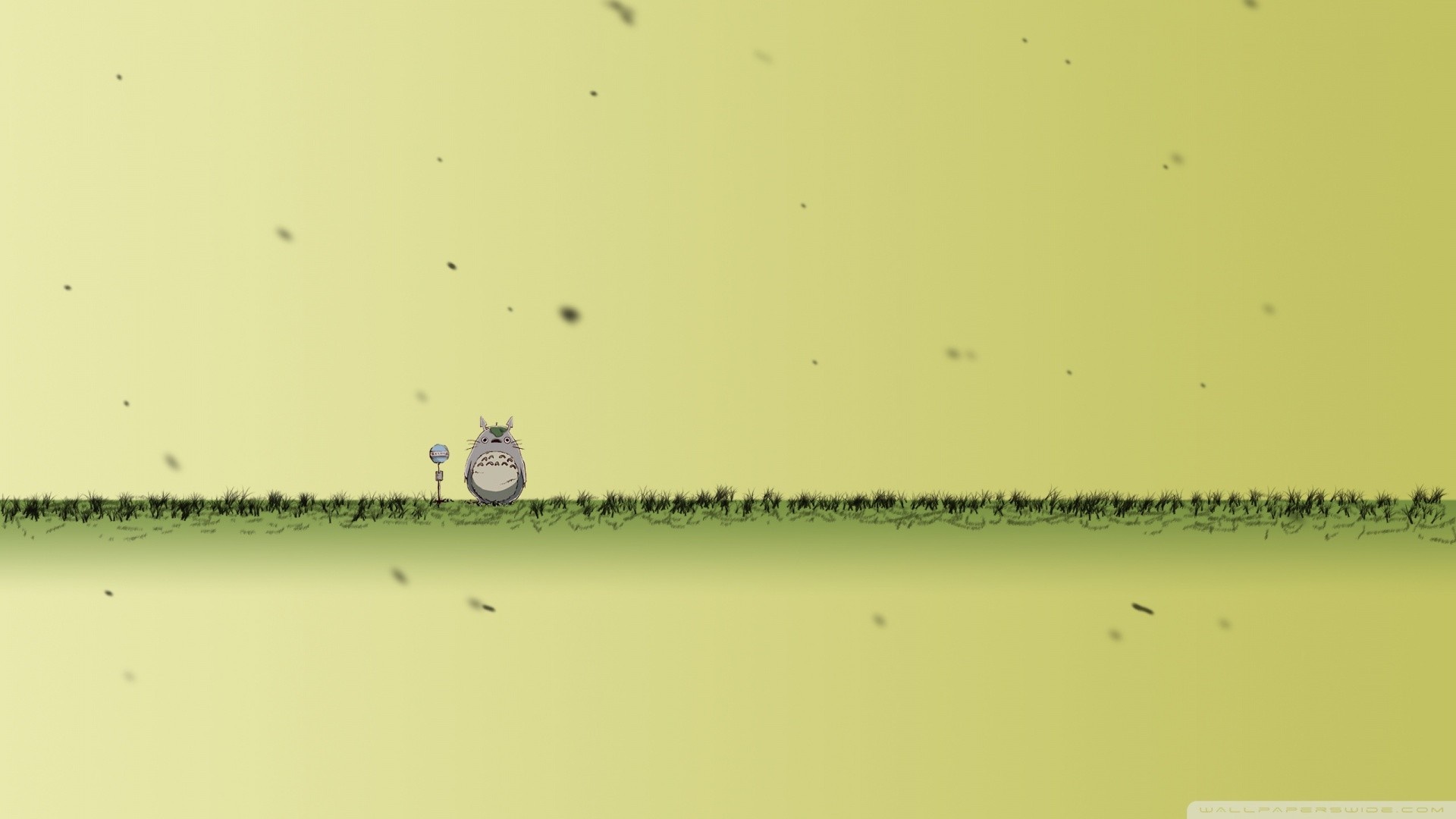 Totoro in a grassy field with falling particles HD Wallpaper