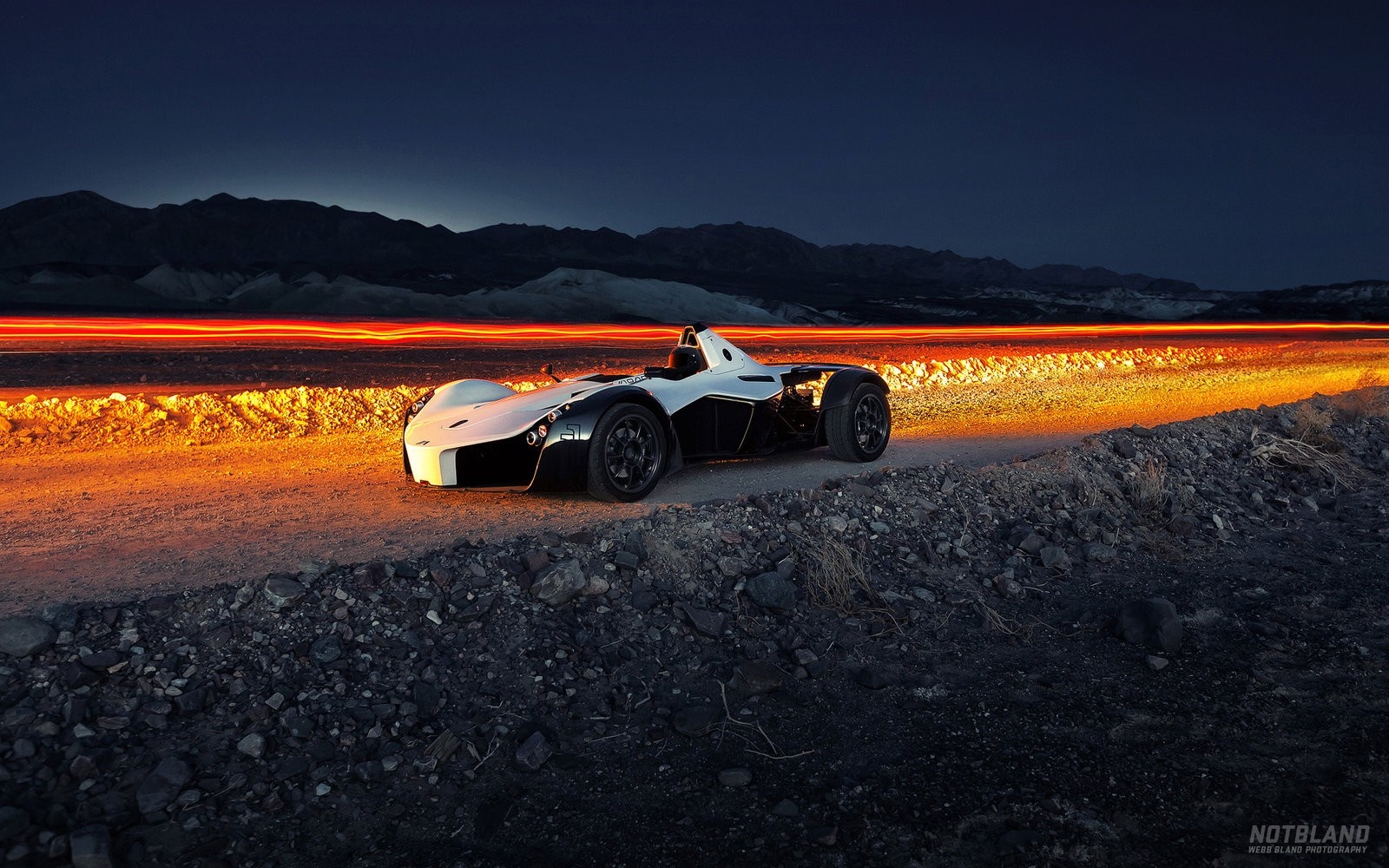 BAC Mono sports car on a dirt road at dusk HD Wallpaper