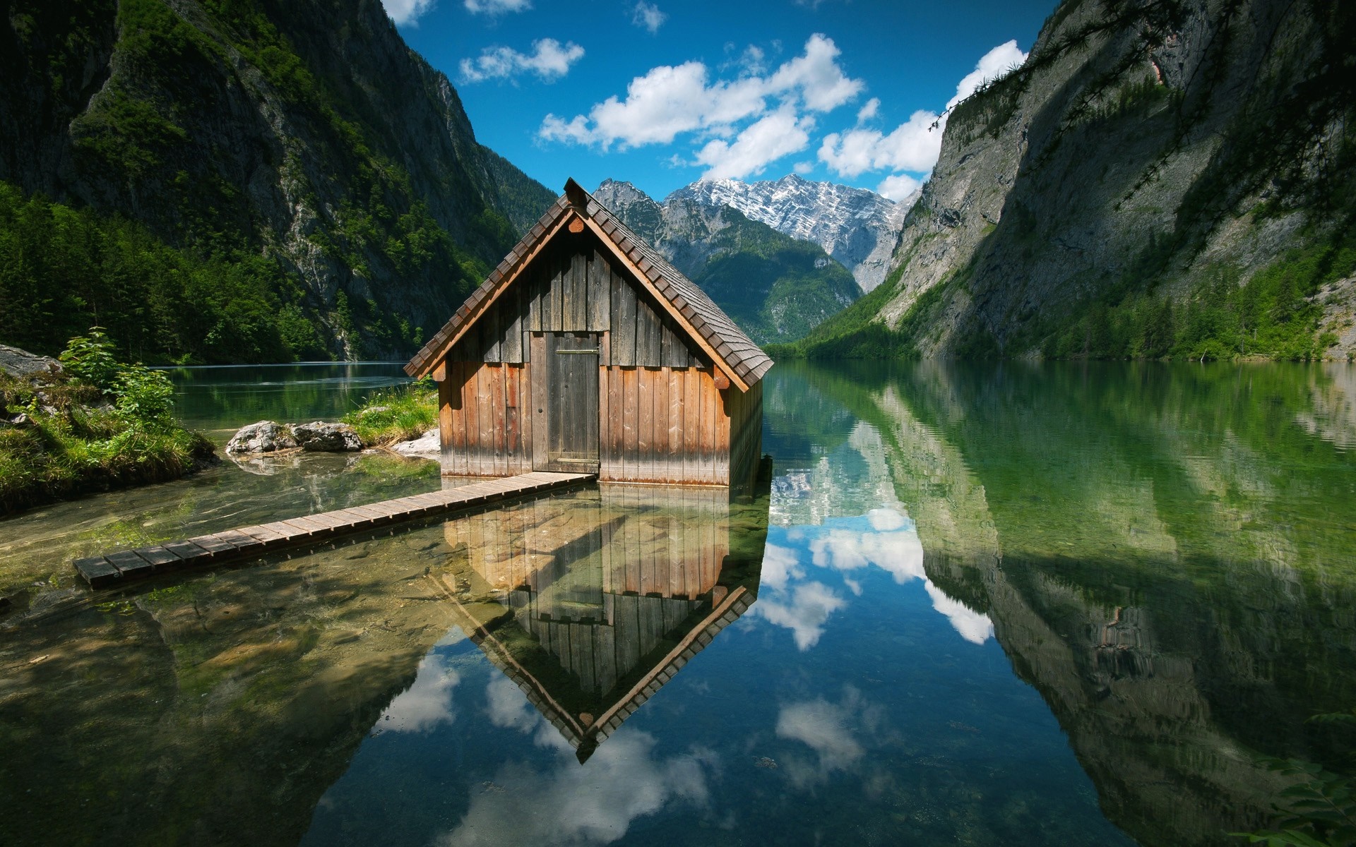 Wooden boathouse on a clear lake with mountains HD Wallpaper