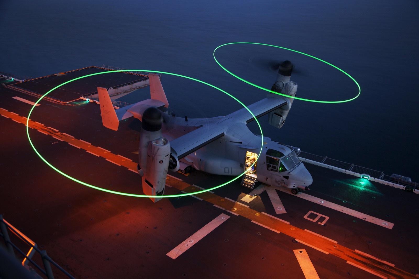 CV-22 Osprey aircraft on a ship deck at night HD Wallpaper
