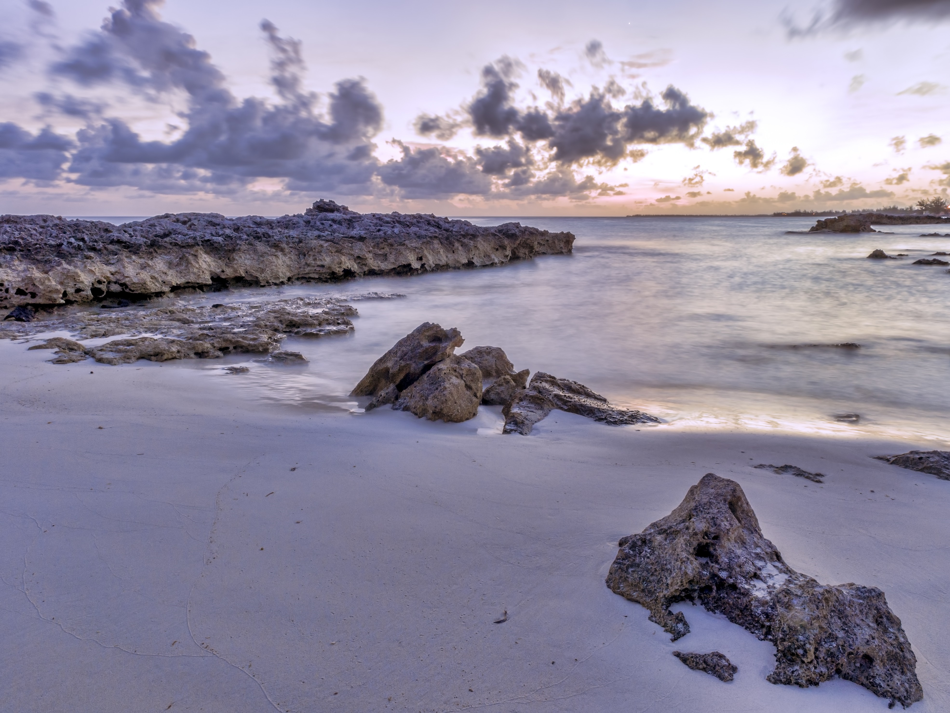 Rocky shore at sunset with clouds over the ocean HD Wallpaper