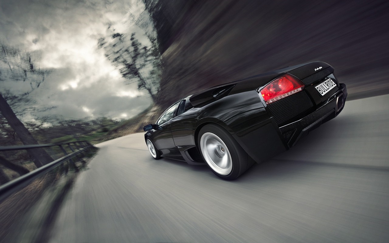Black Lamborghini Murcielago LP640 4 driving on a road HD Wallpaper