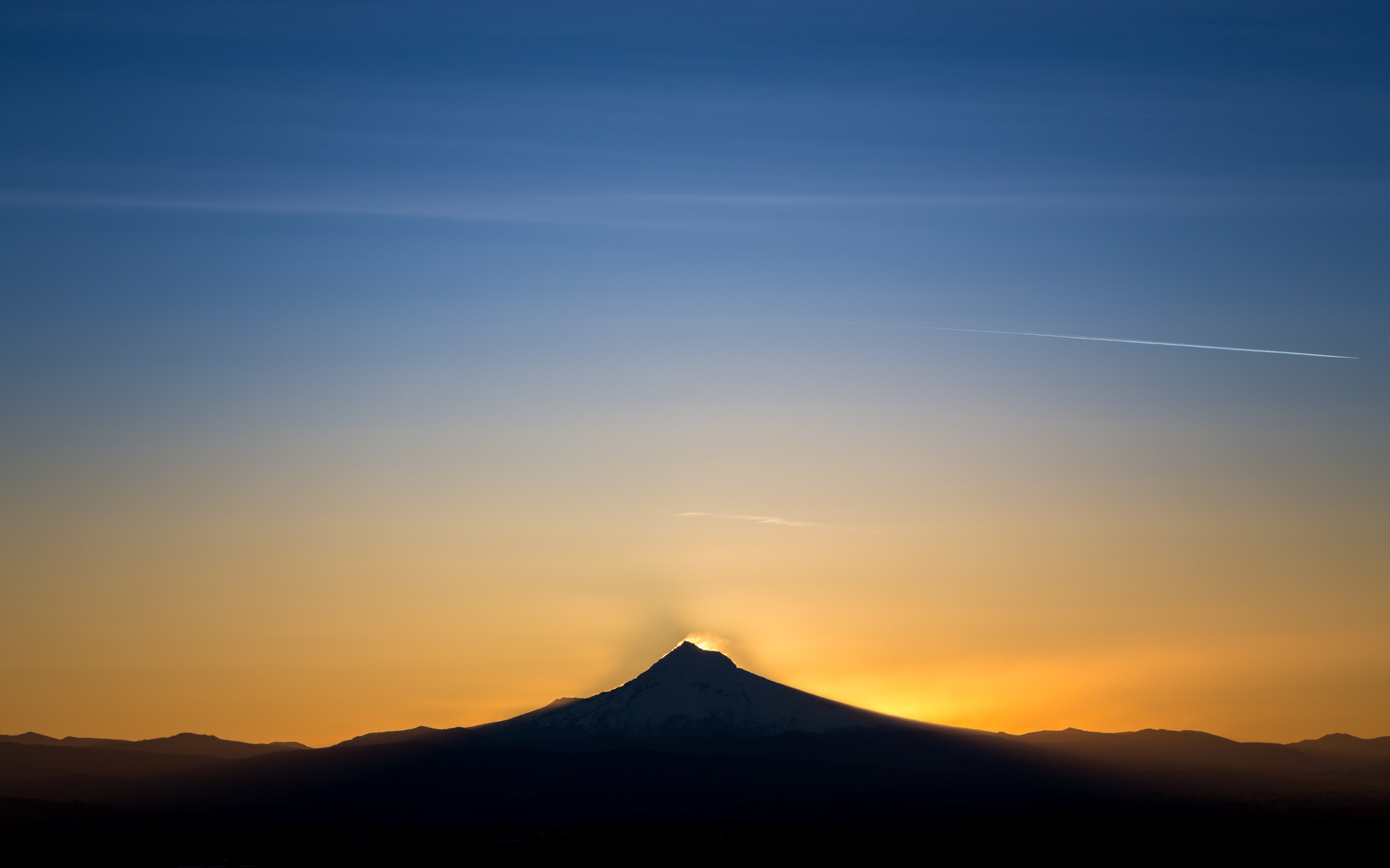 Sunset over mountains with contrail HD Wallpaper
