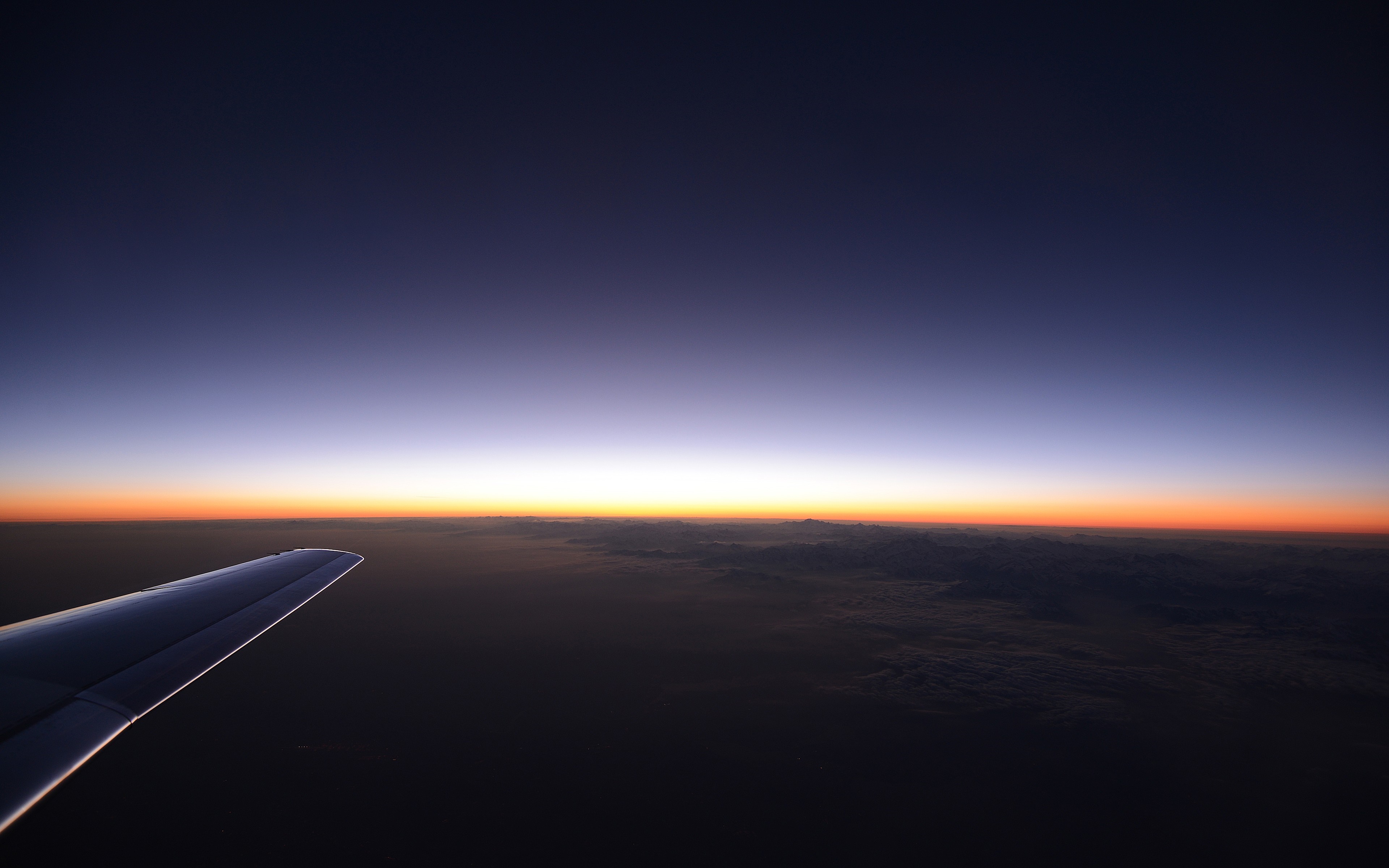 Airplane wing at sunset over clouds HD Wallpaper