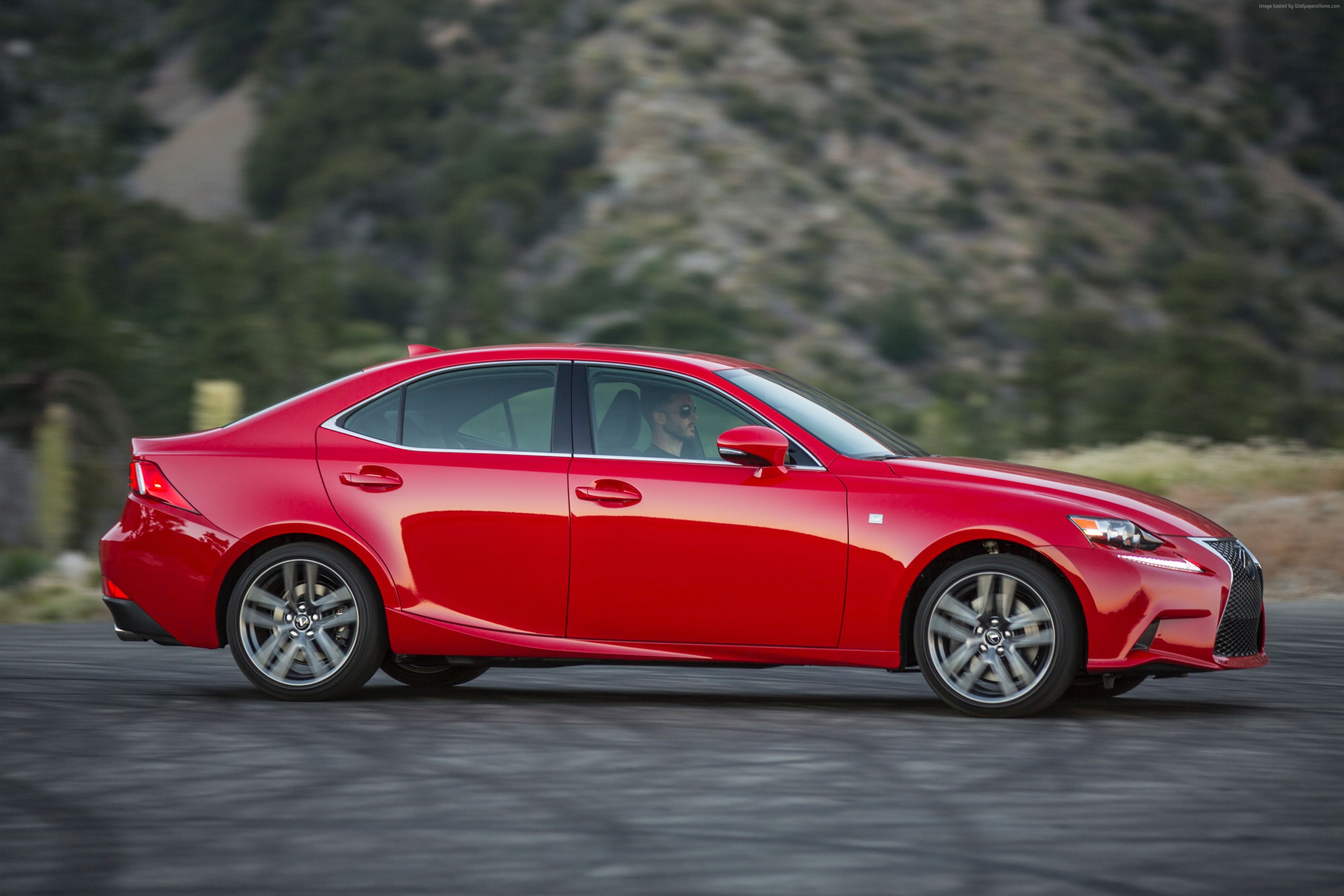 Red Lexus IS200T driving on a road HD Wallpaper