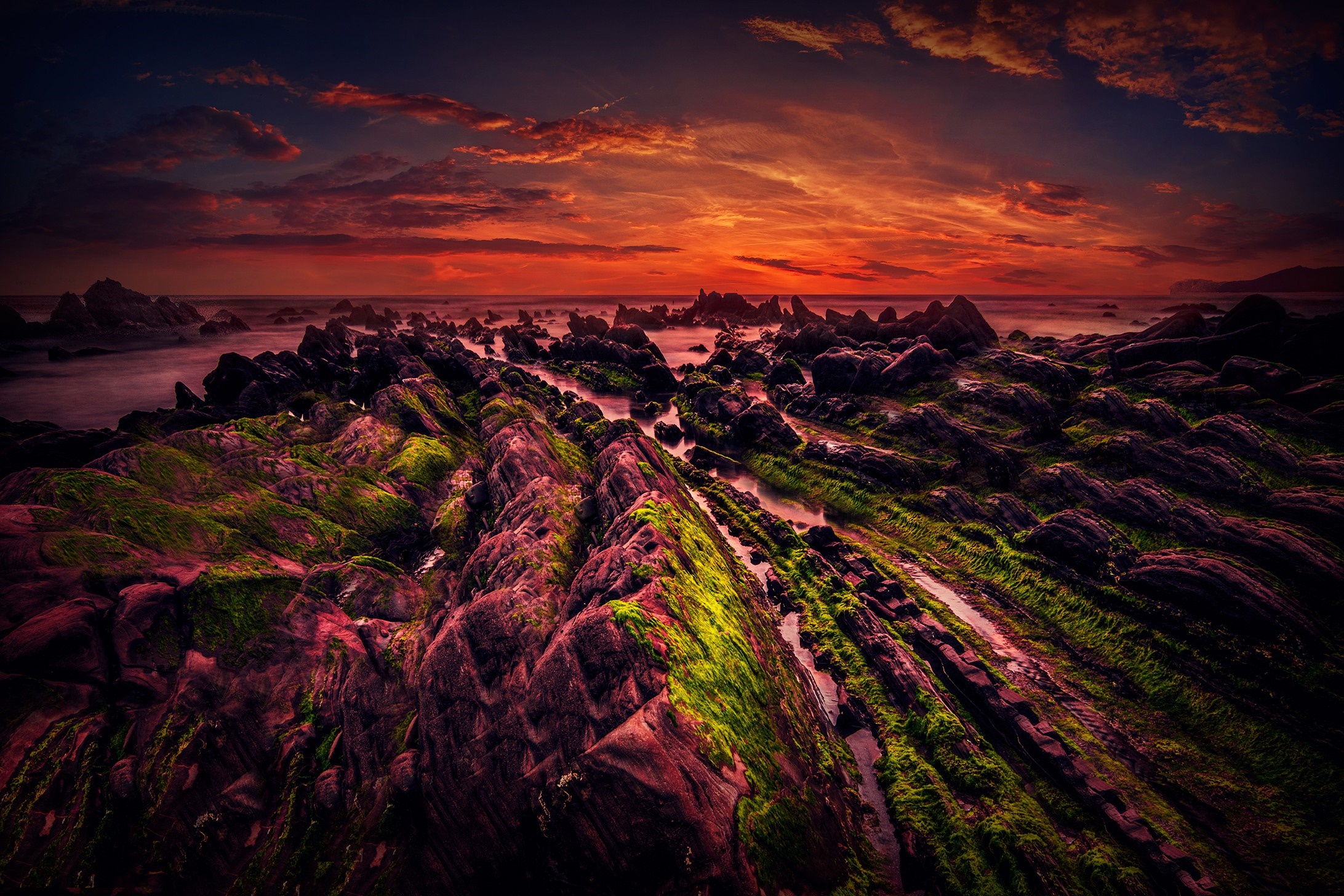 Ruined stone building on a grassy coast at sunset HD Wallpaper