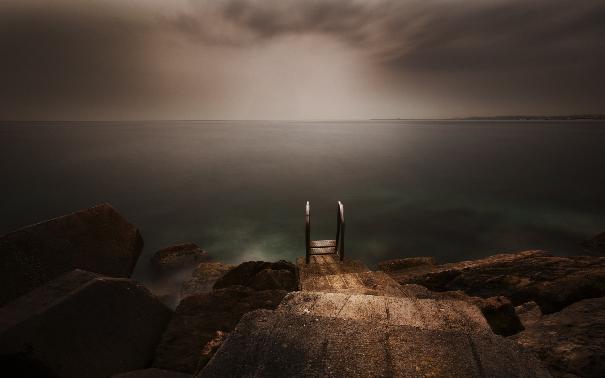 Wooden ladder on rocks by the sea at dusk HD Wallpaper