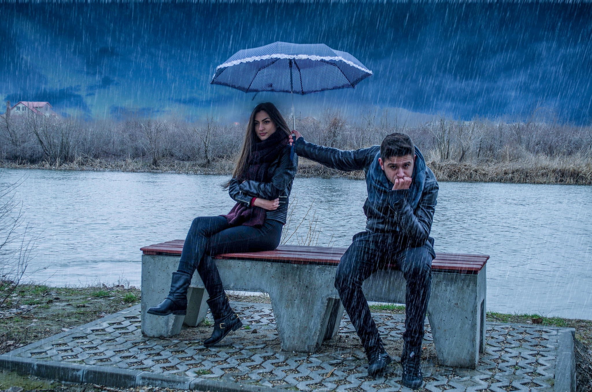 Couple sharing an umbrella in the rain by a lake HD Wallpaper