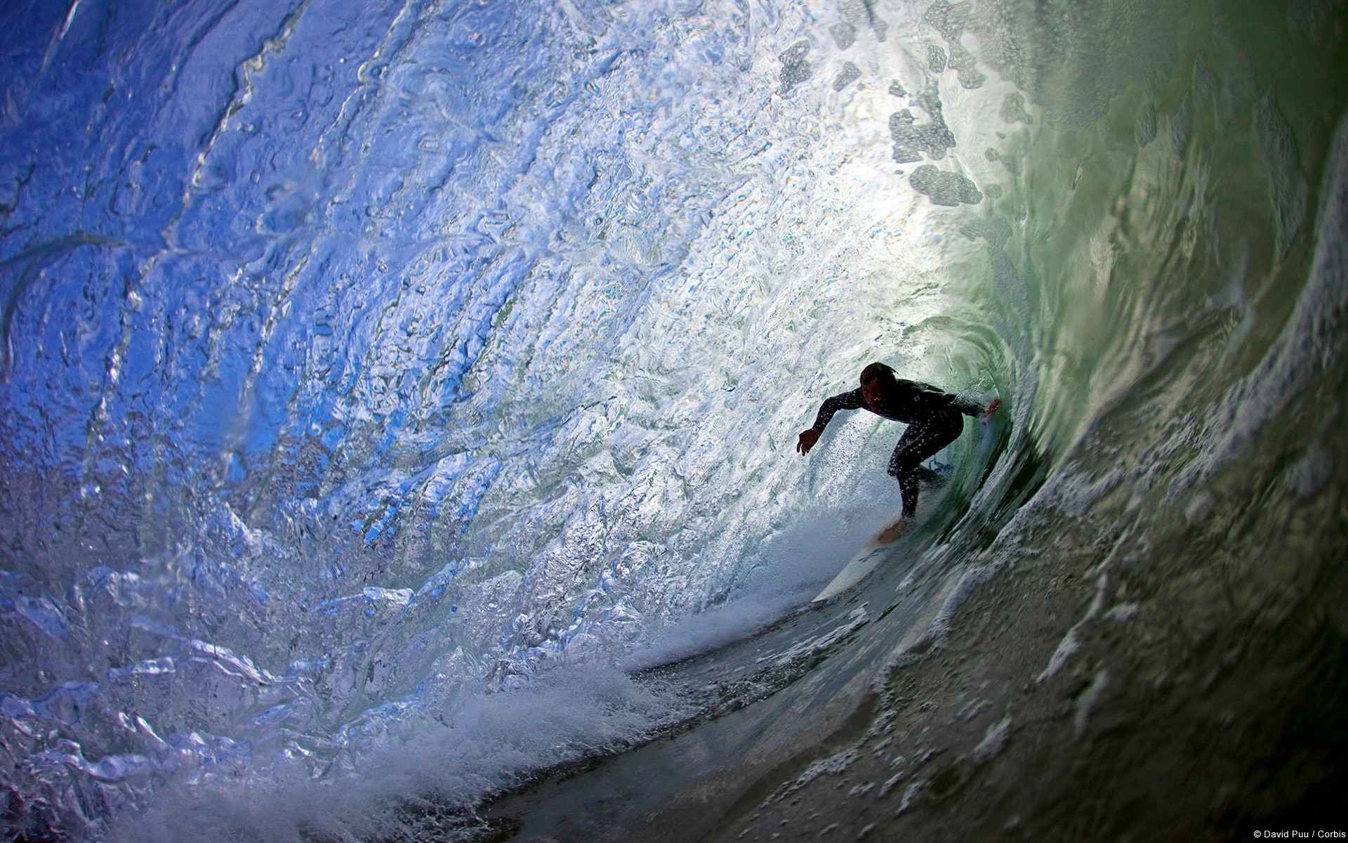 Surfer riding a wave inside a barrel HD Wallpaper