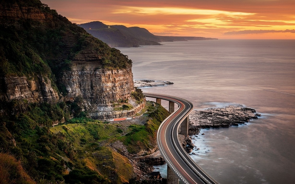 Sea Cliff Bridge at sunset over the ocean HD Wallpaper