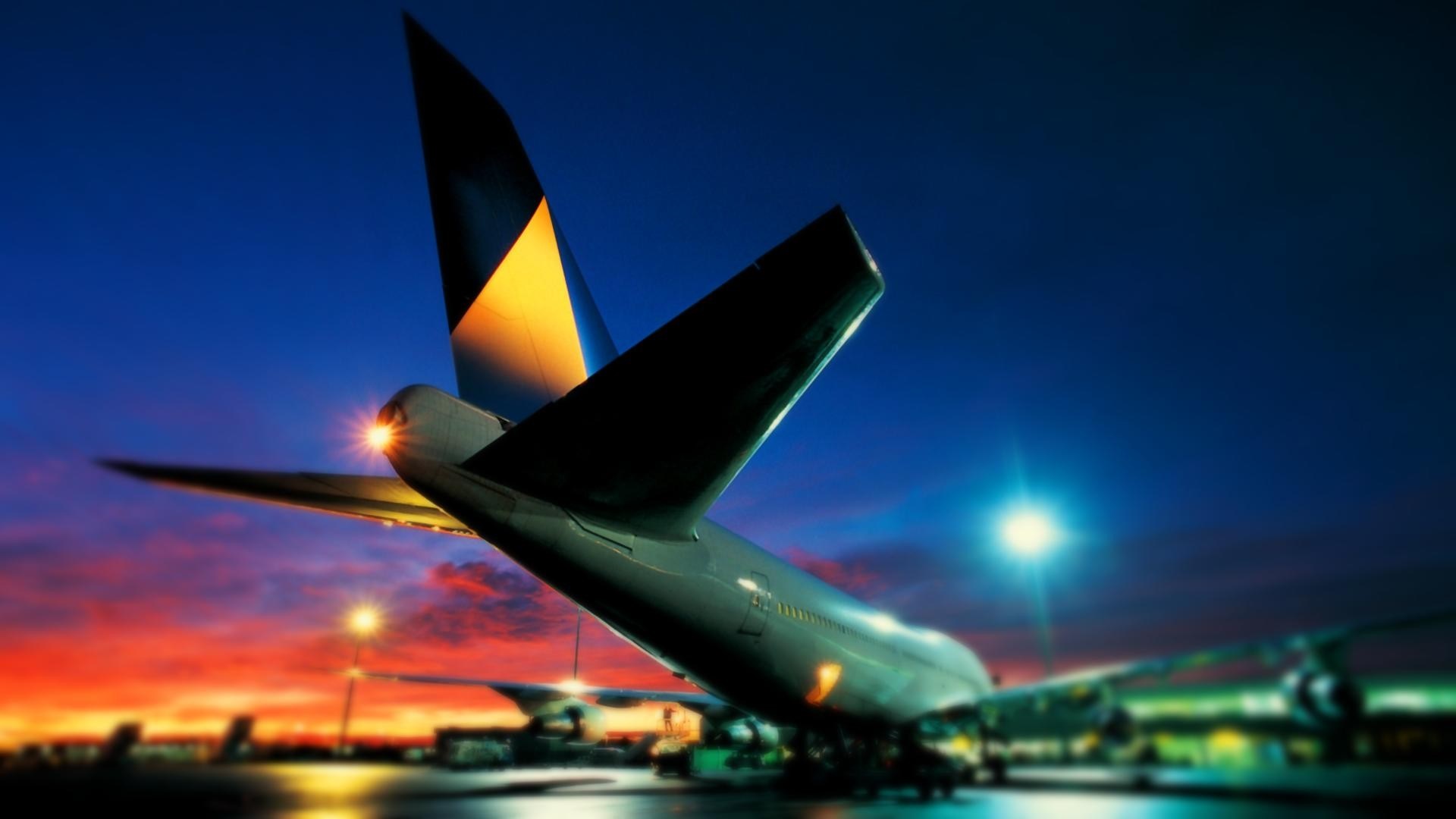 Airplane tail at dusk with colorful sky HD Wallpaper