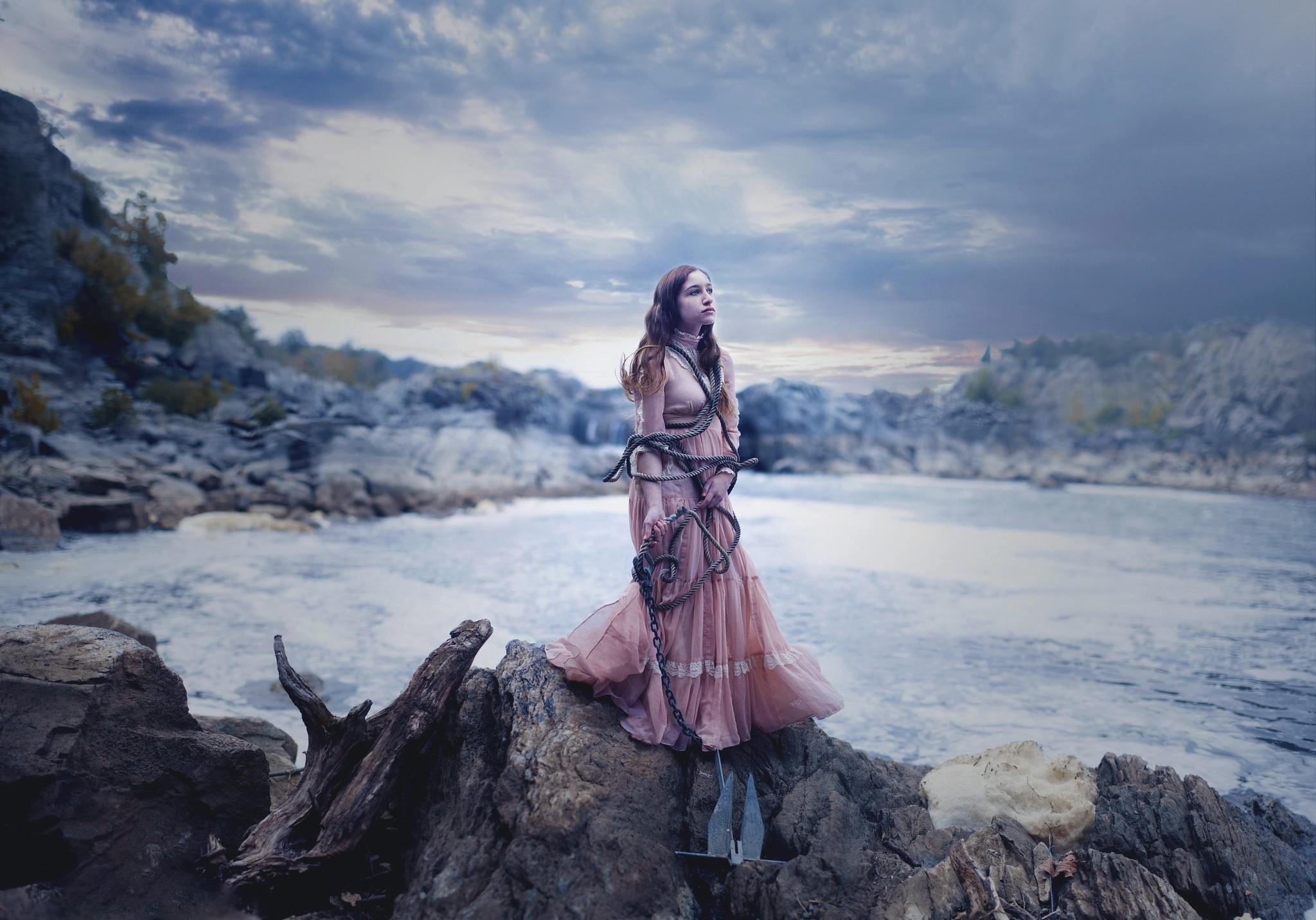 Woman tied with chains on rocks by the sea HD Wallpaper