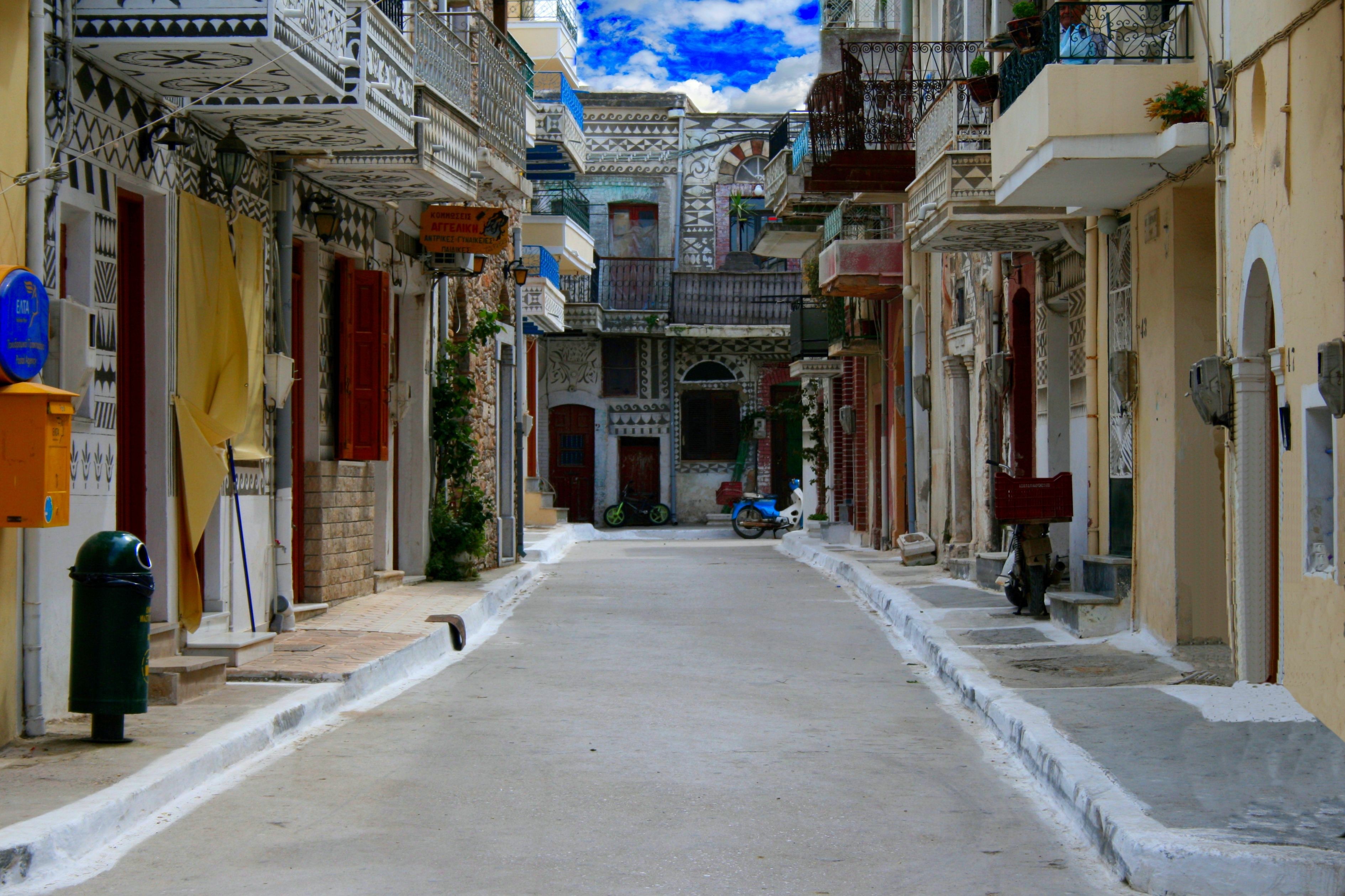 Pyrgi village street with decorated buildings and balconies HD Wallpaper