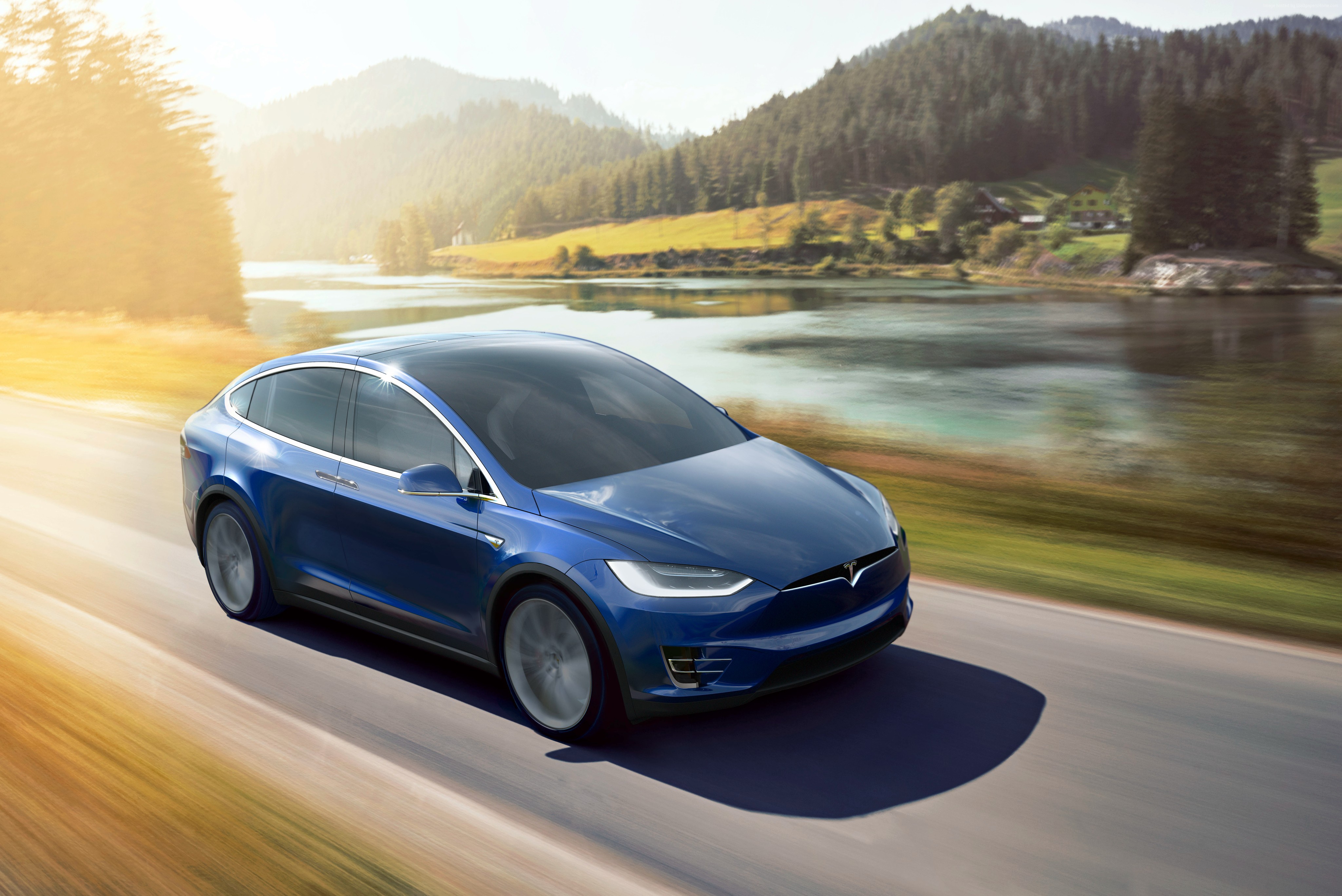 Blue Tesla Model X P90D driving on a scenic road HD Wallpaper