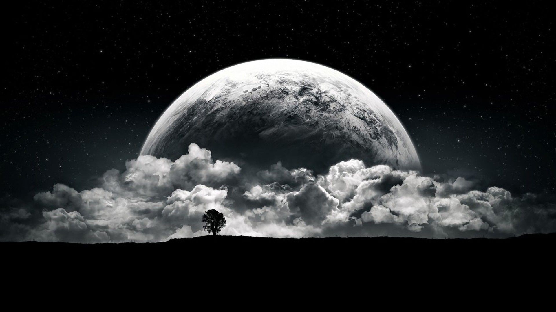 Planet and clouds over silhouetted landscape HD Wallpaper