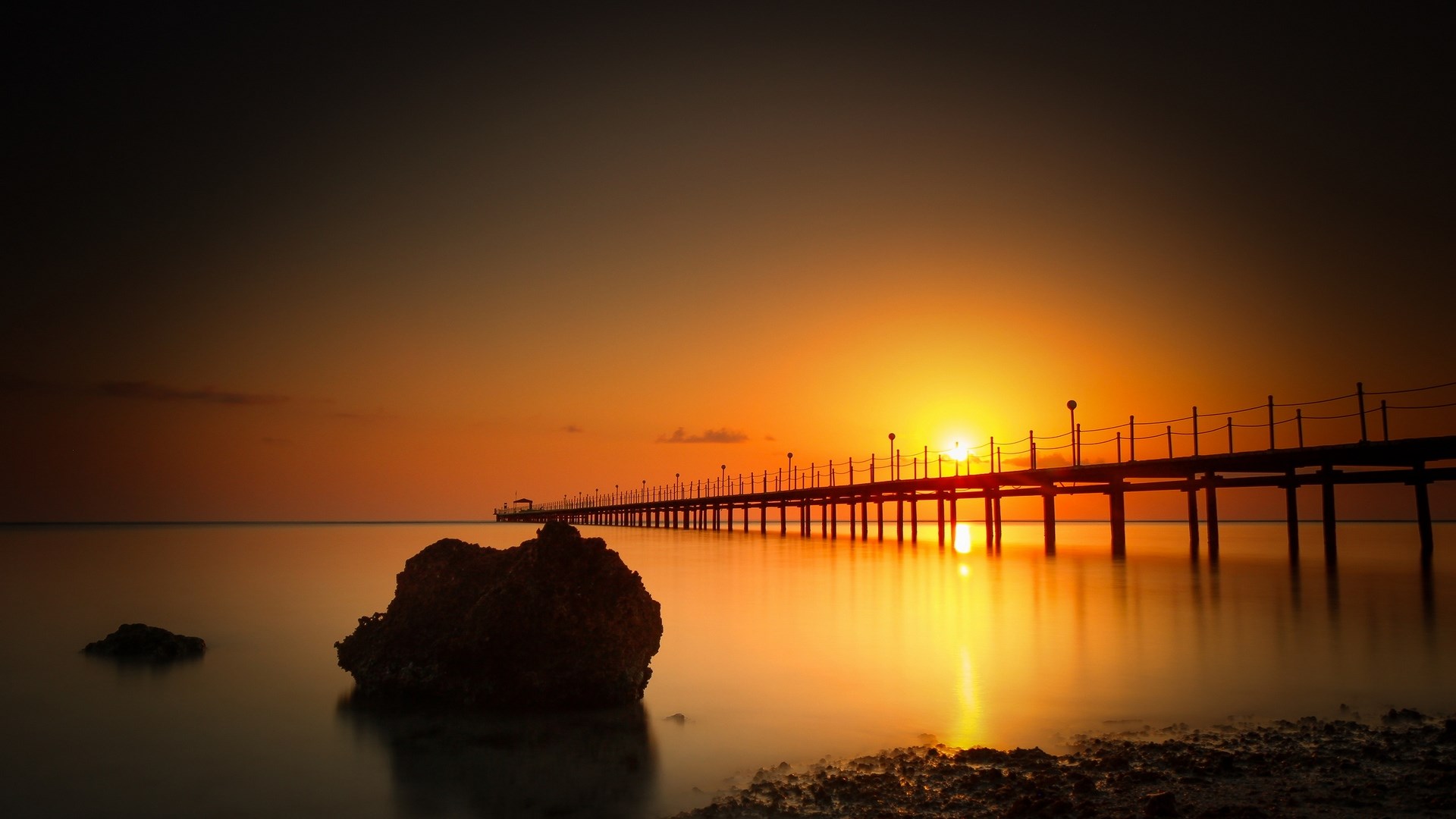 Pier over the ocean at sunset HD Wallpaper