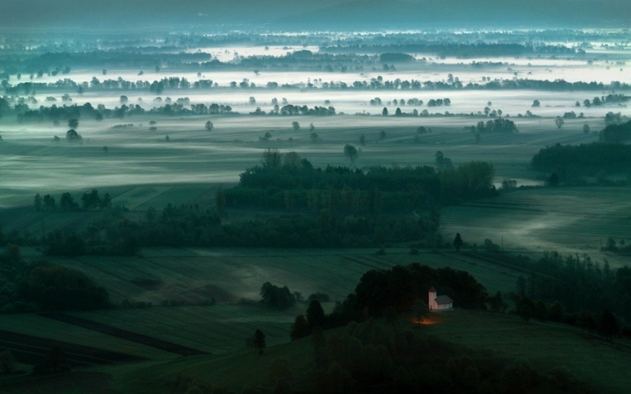 Misty valley with a small church at dawn HD Wallpaper