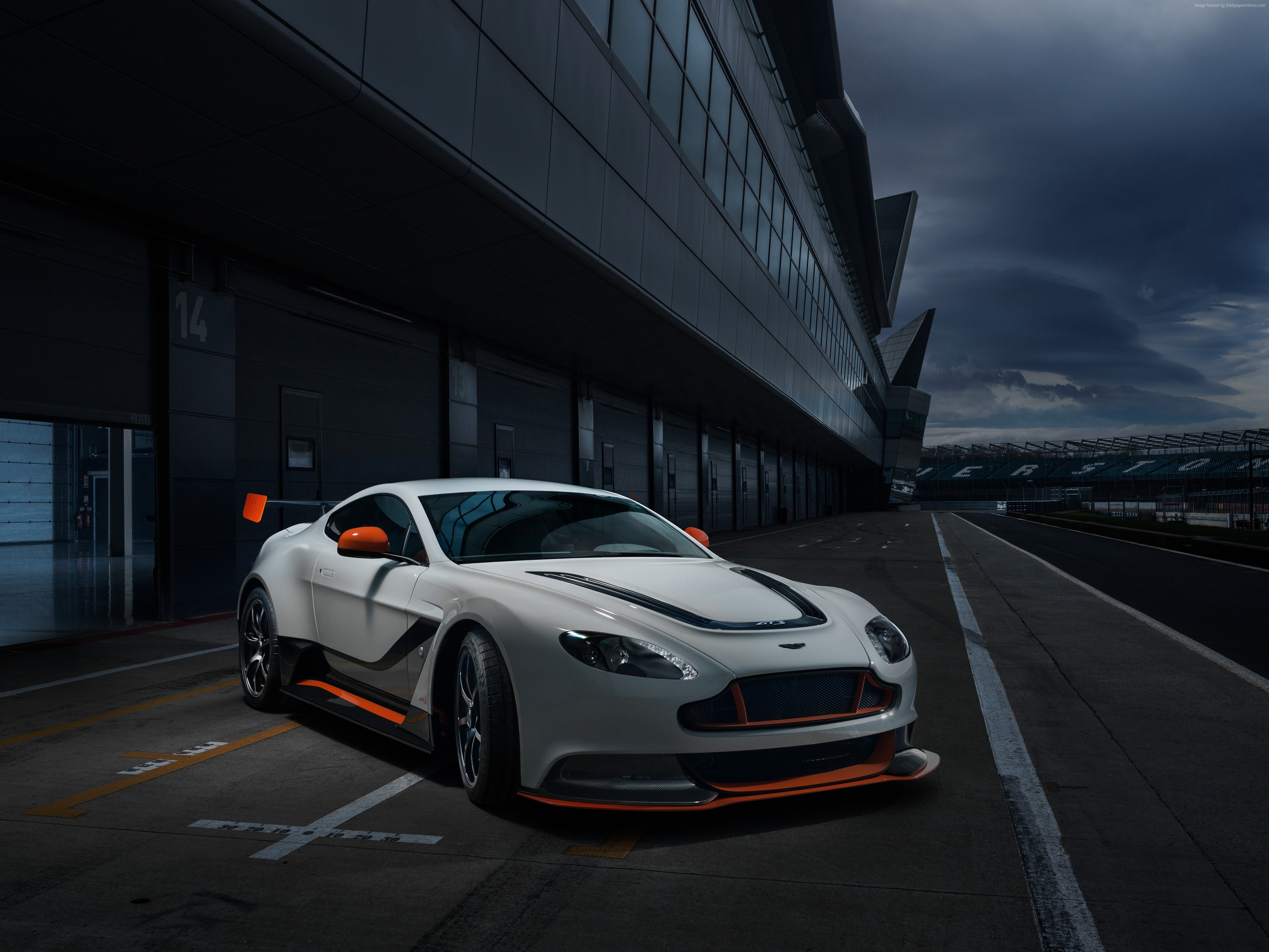 White Aston Martin Vantage sports car on a racetrack HD Wallpaper