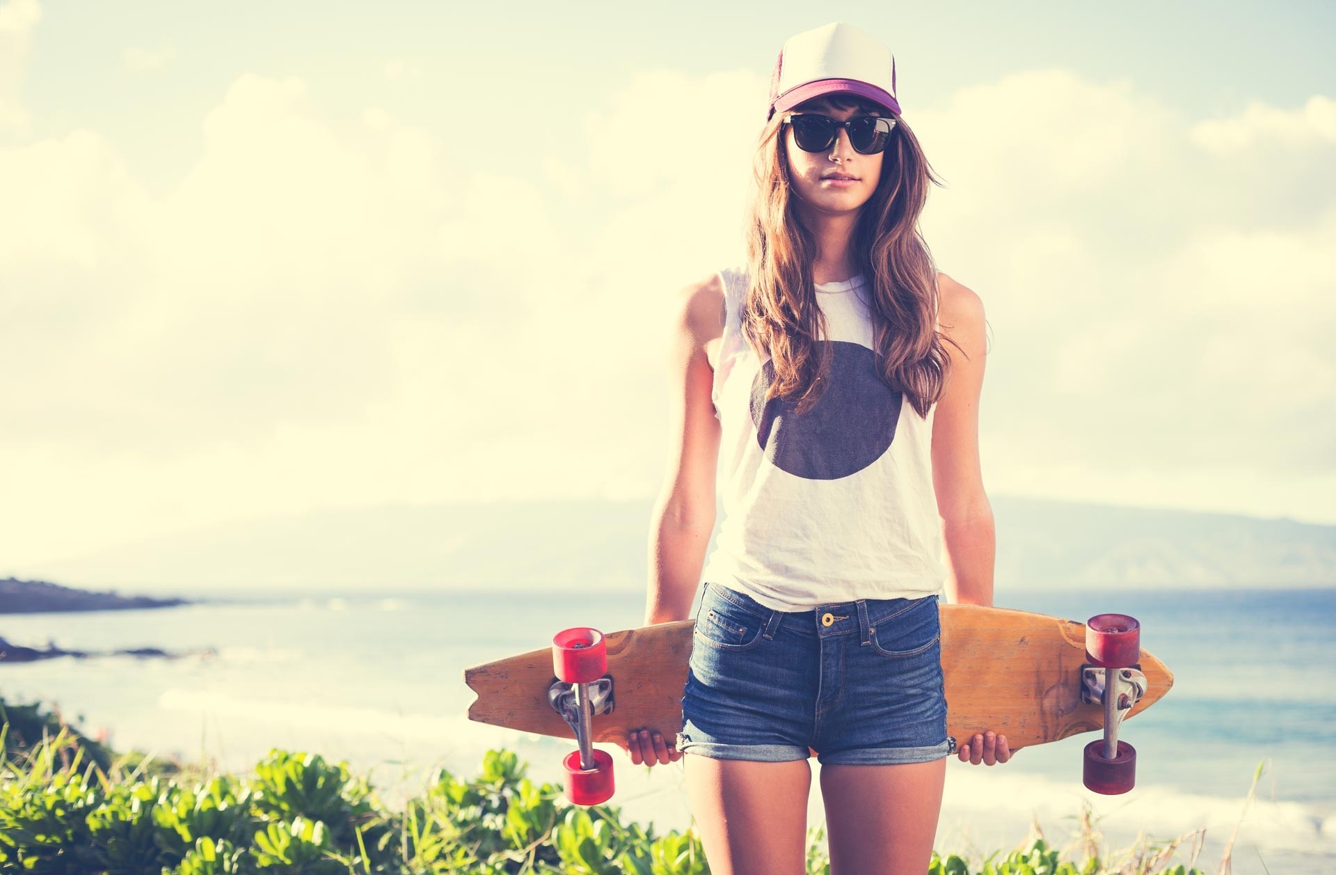Woman with skateboard at the beach HD Wallpaper