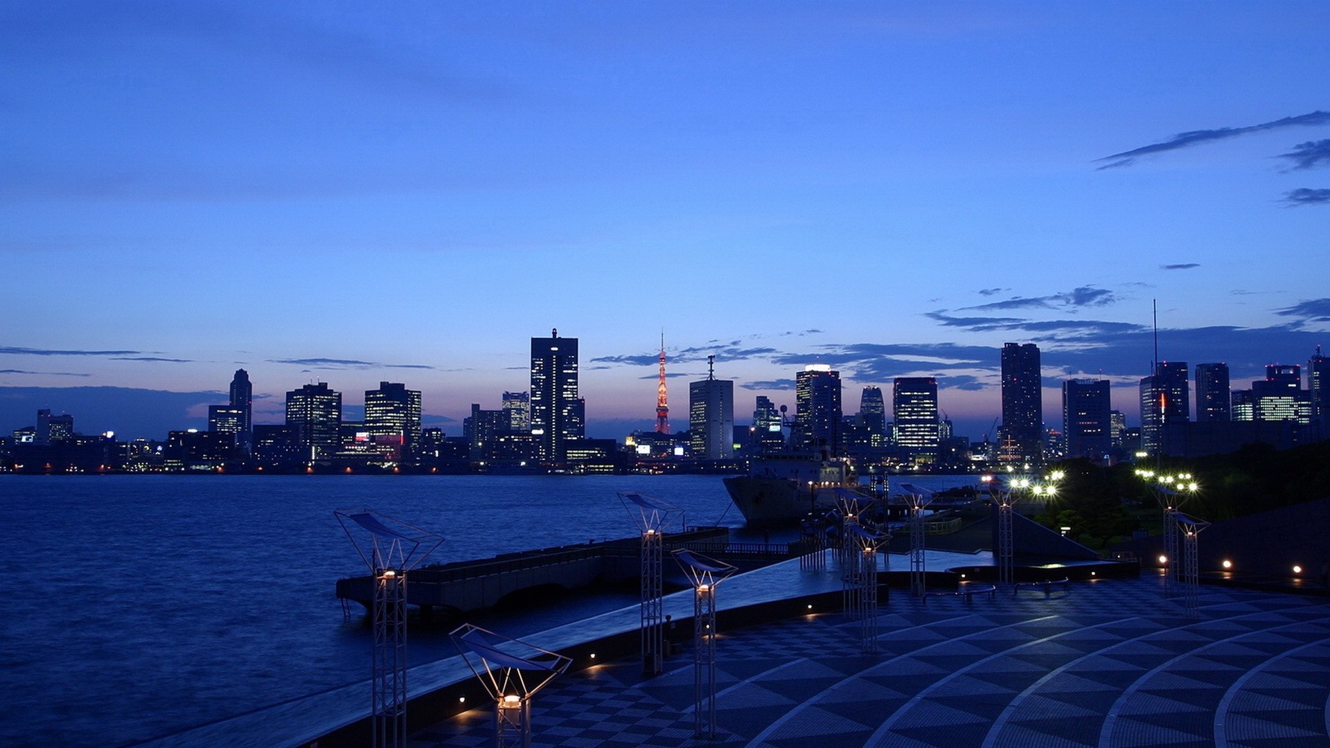City skyline at dusk over the water with a tower HD Wallpaper