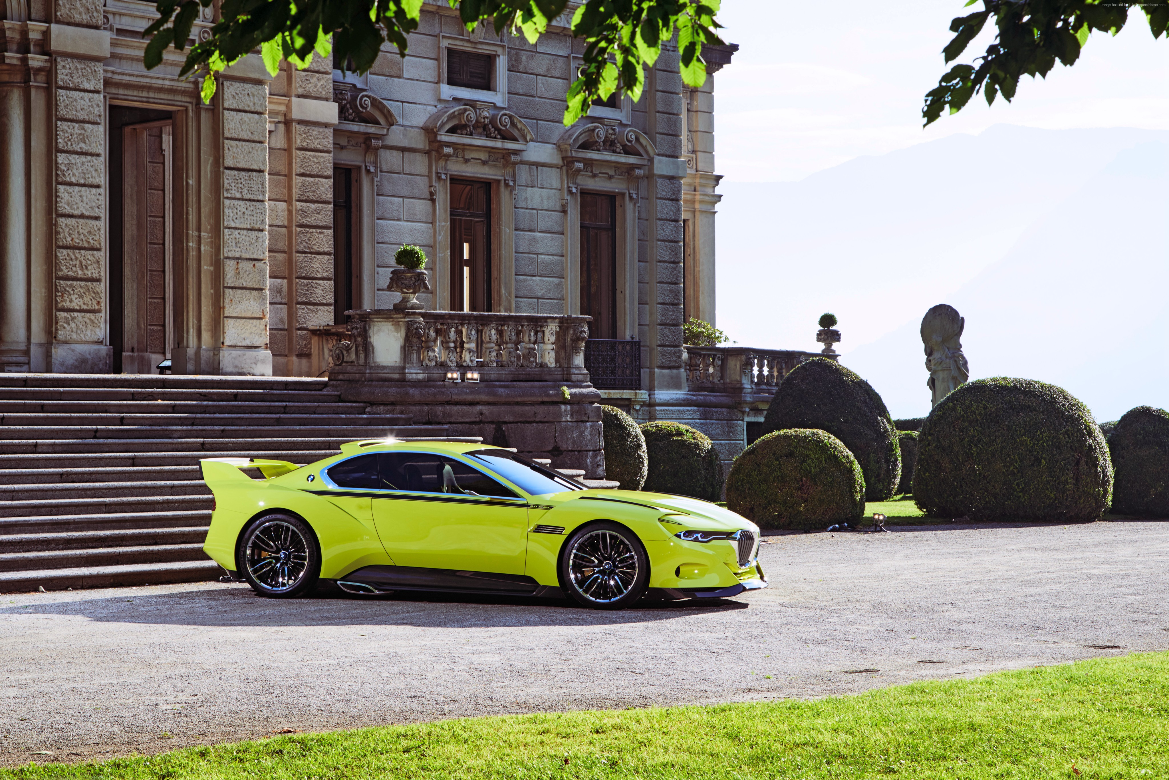 Yellow BMW 3.0 CSL sports car parked in front of a mansion HD Wallpaper