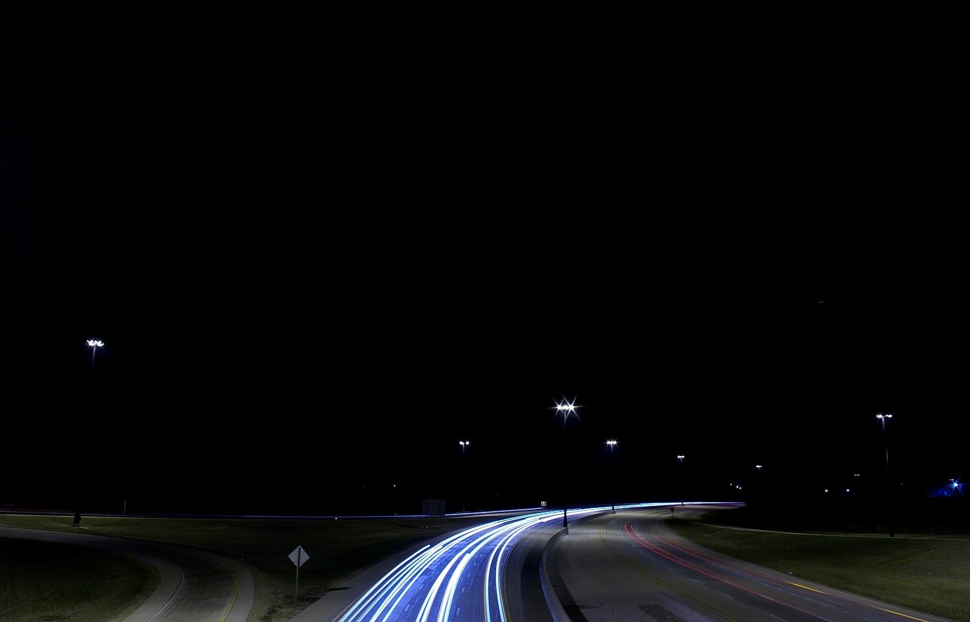 Night highway with light trails and streetlights HD Wallpaper