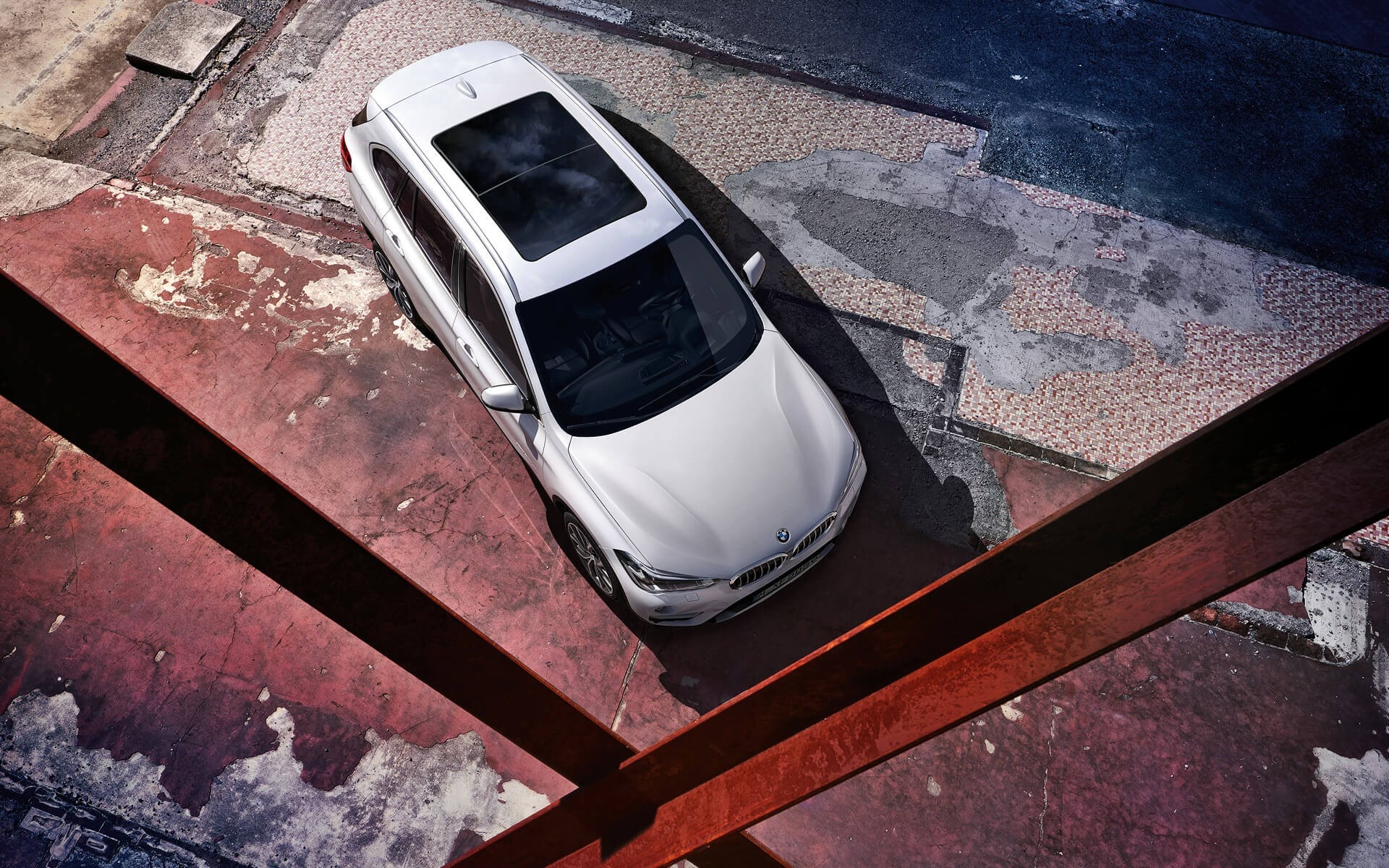 White BMW X1 parked on a textured surface HD Wallpaper