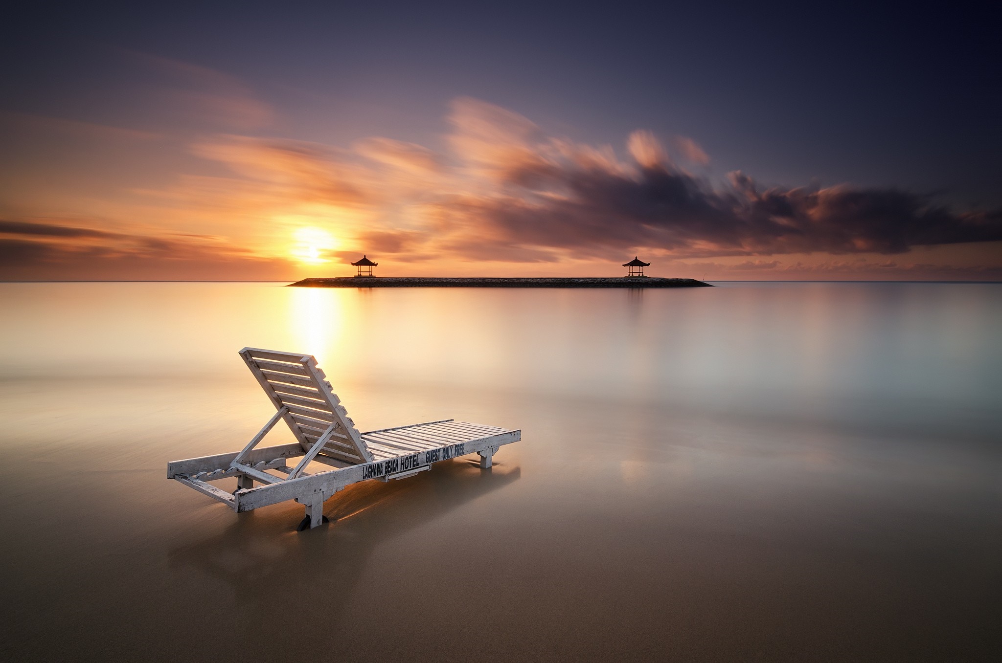 Beach chair at sunrise with pagodas in Bali, Indonesia HD Wallpaper